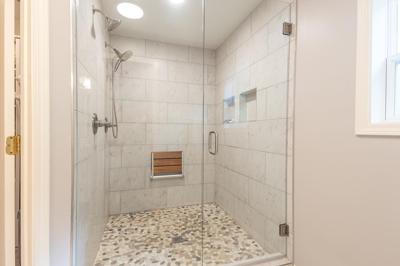 Total Primary Bath Renovation with this Double Shower, New Tile Floors and Double Vanity