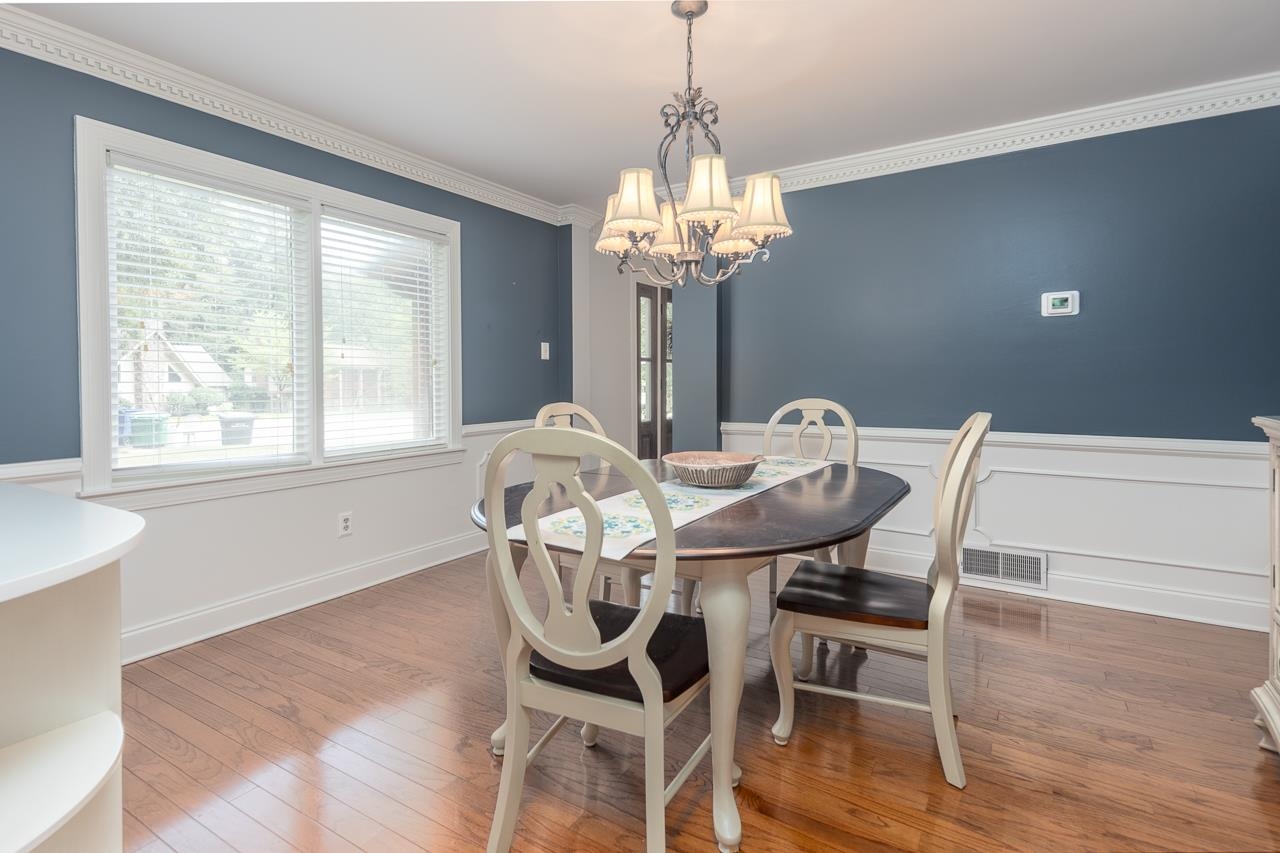 Picture Window, Hardwood Floors, & Crown Moldings In Dining Room.