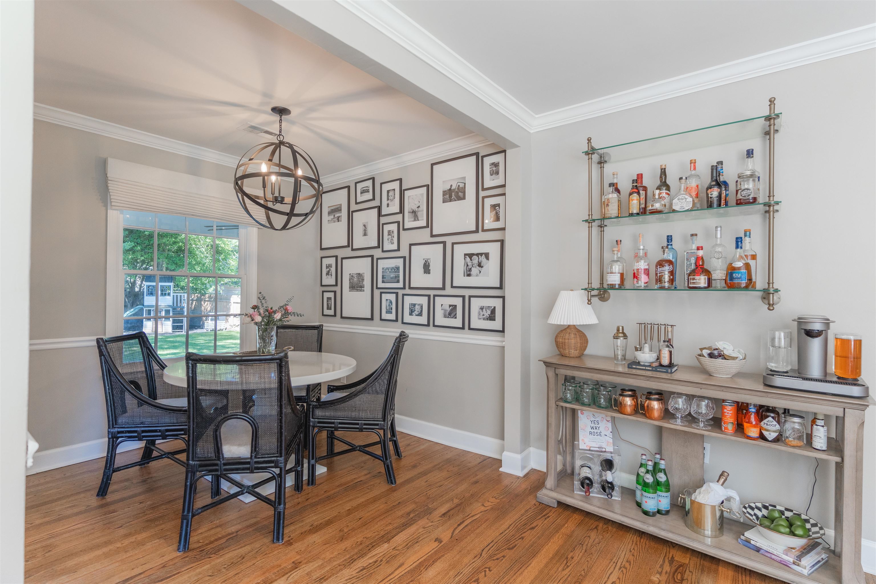 Dining area with hardwood / wood-style flooring, a notable chandelier, and ornamental molding