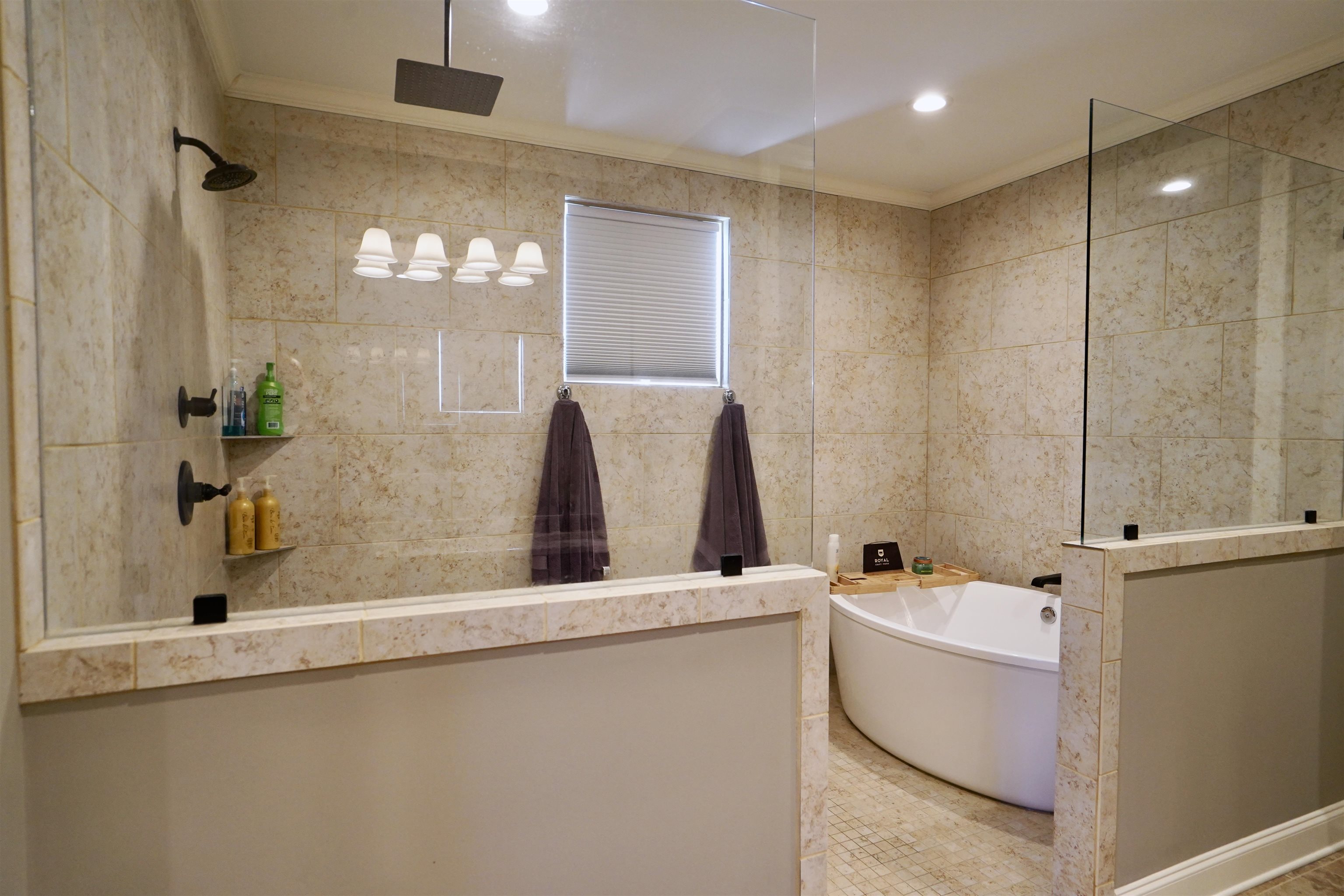 Bathroom featuring crown molding, tile walls, and separate shower and tub