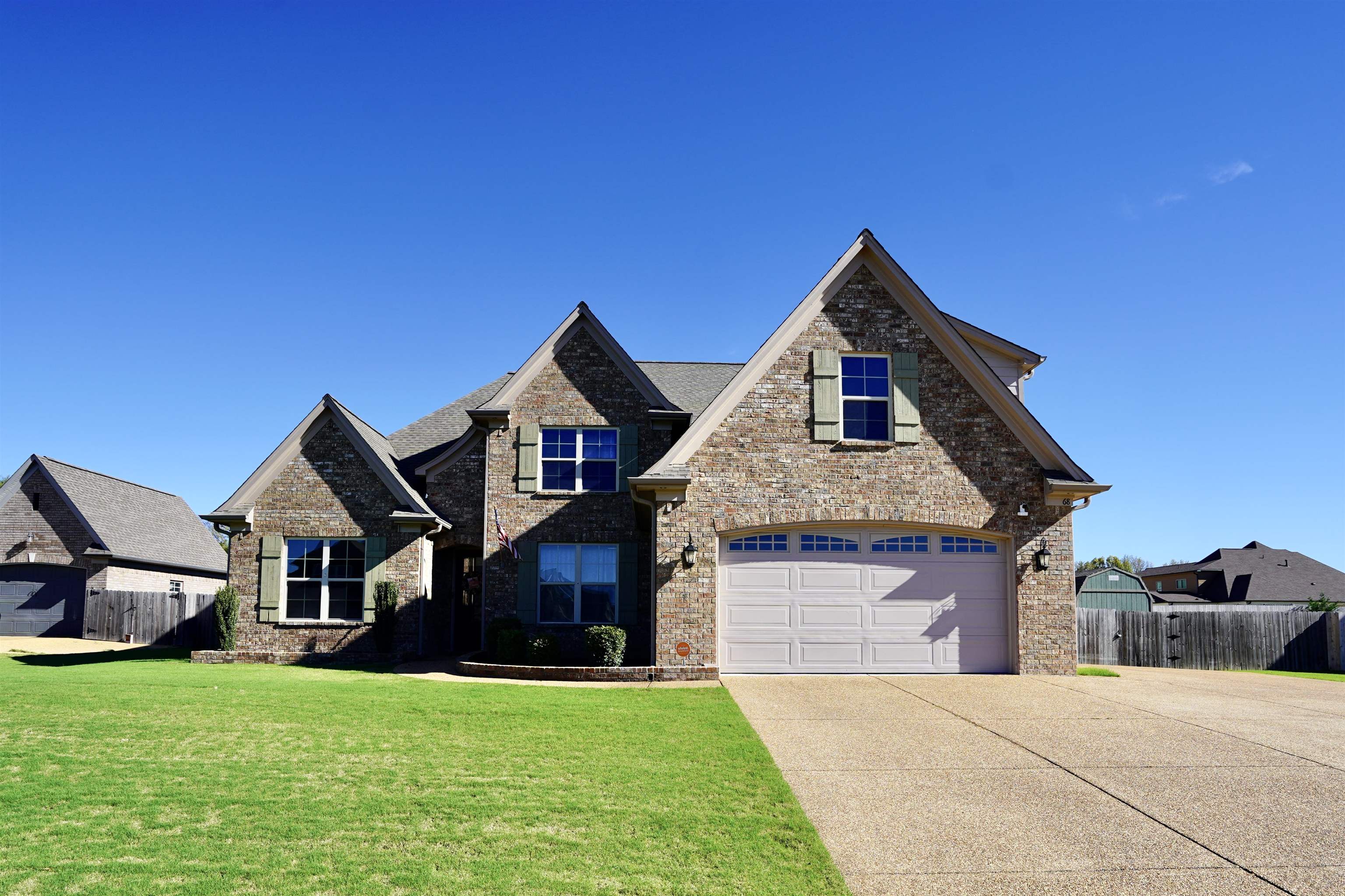 View of front of home with a garage and a front lawn