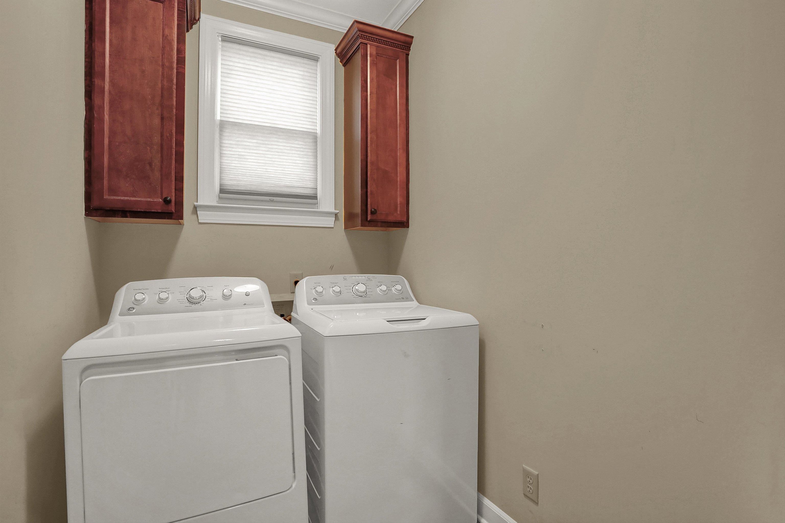 Separate laundry room adjacent to hall half bath