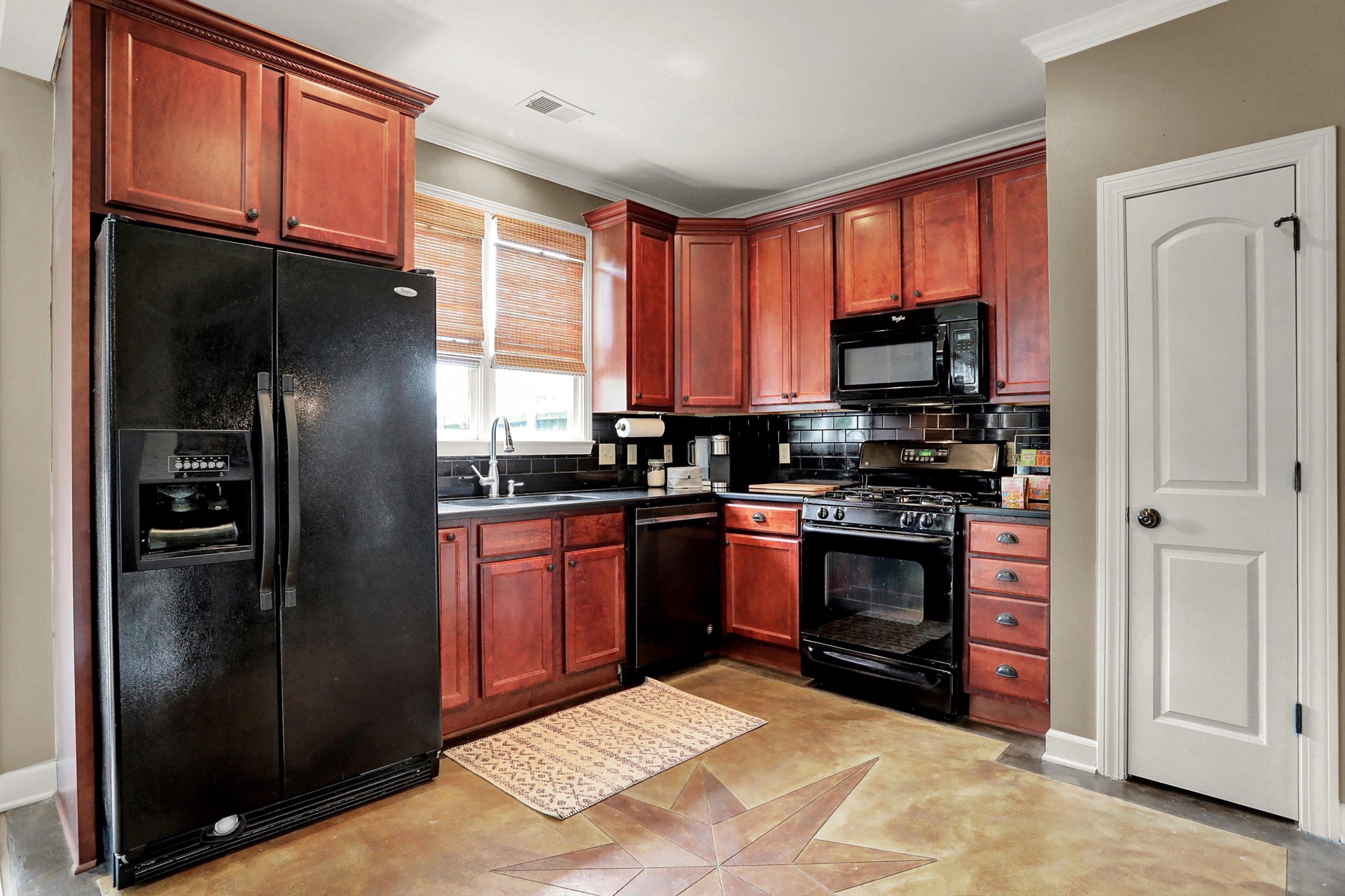 Ample cabinets with large uppers, granite counters, tile backsplash, gas cooking and separate pantry.