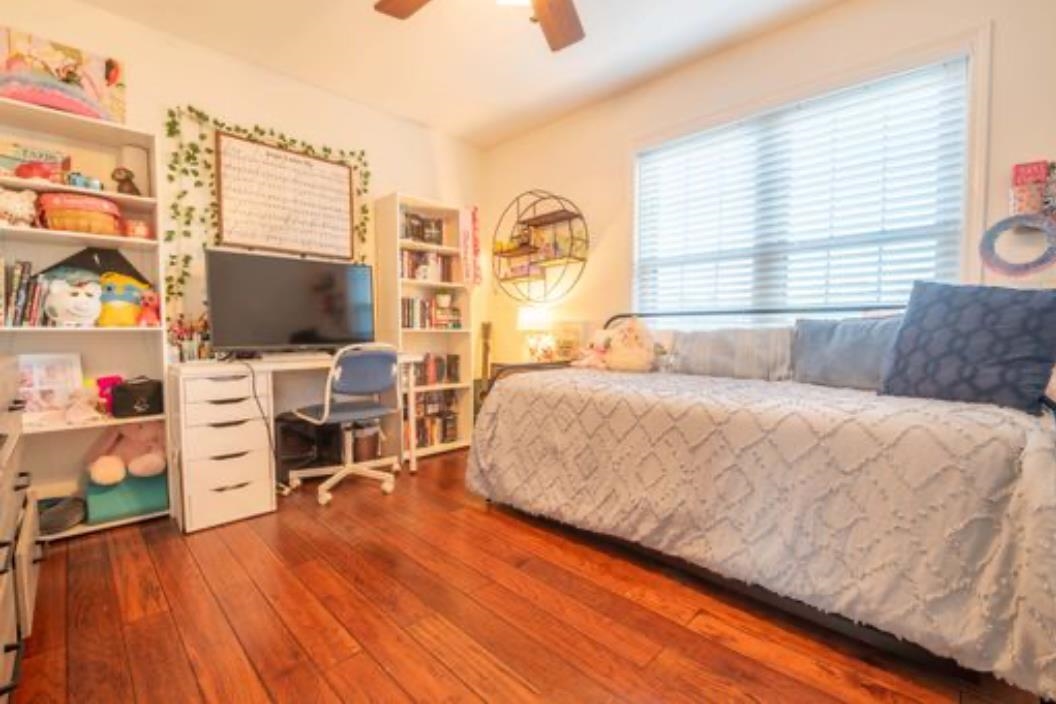 Bedroom featuring ceiling fan and dark hardwood / wood-style flooring