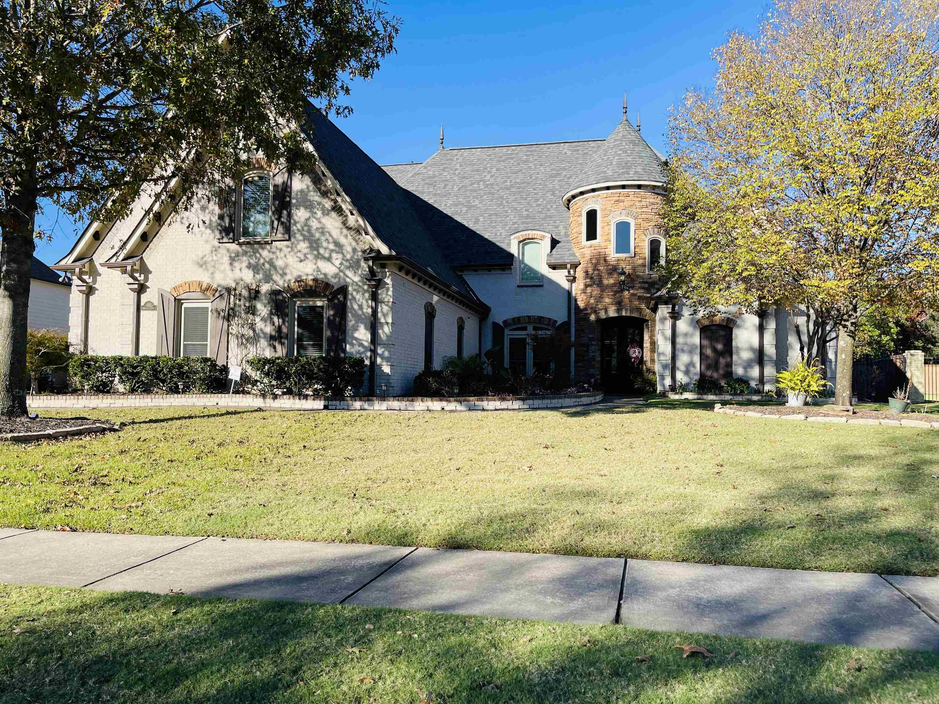 French provincial home featuring a front lawn