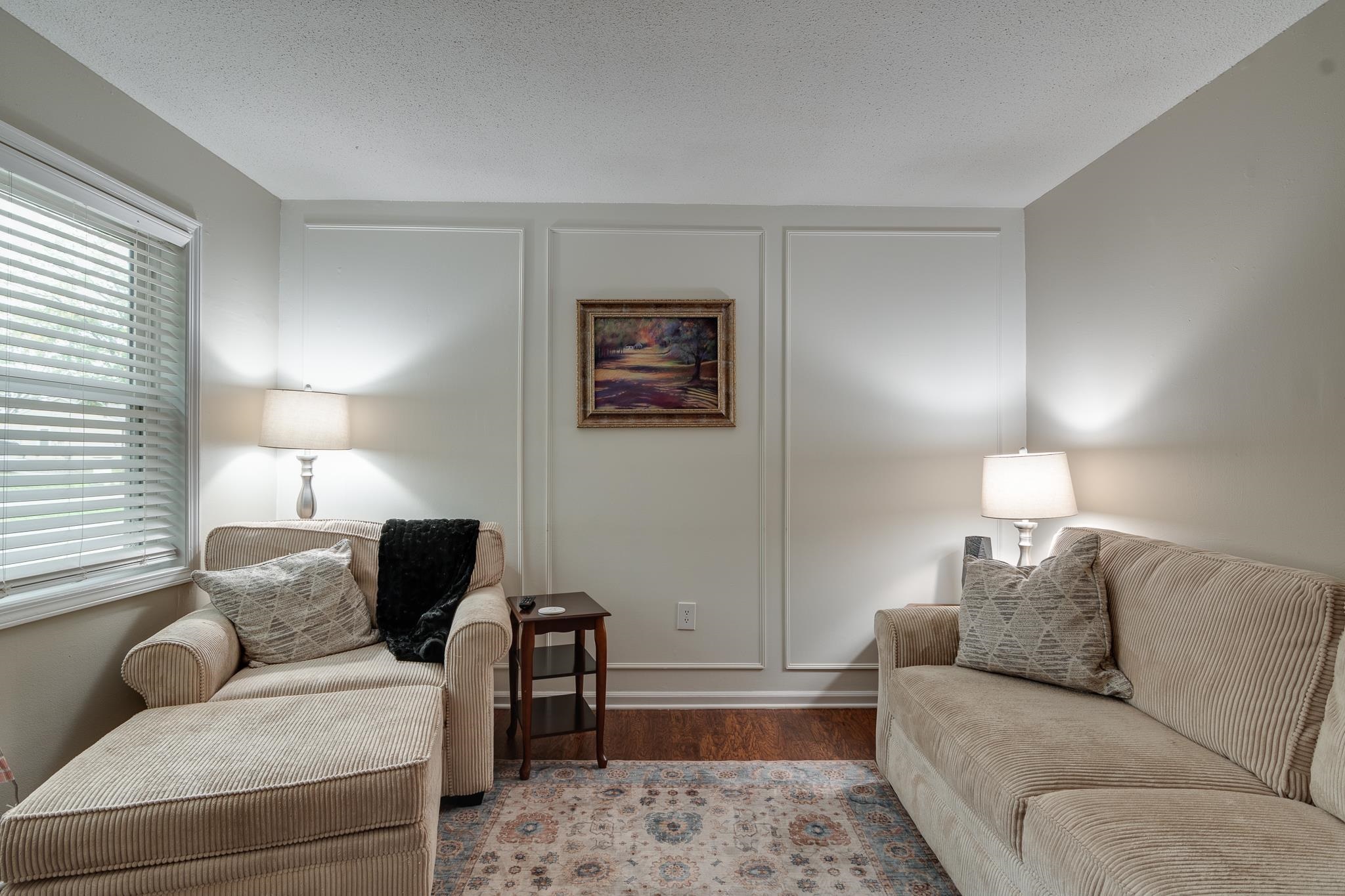 Living room featuring a textured ceiling and light wood-type flooring