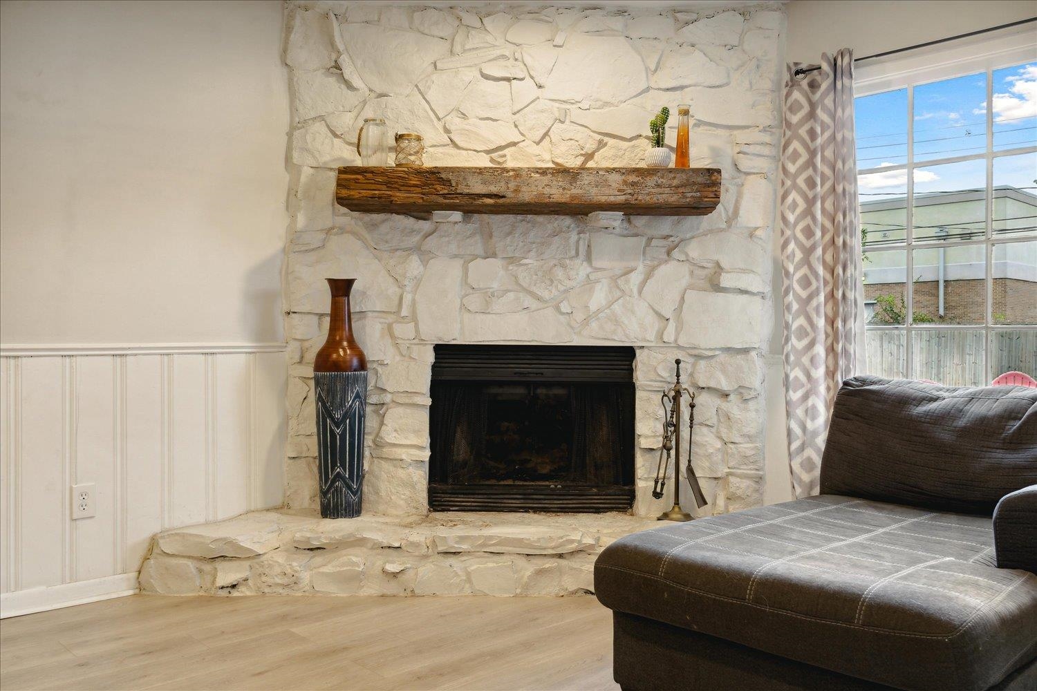 Interior details with hardwood / wood-style flooring and a stone fireplace