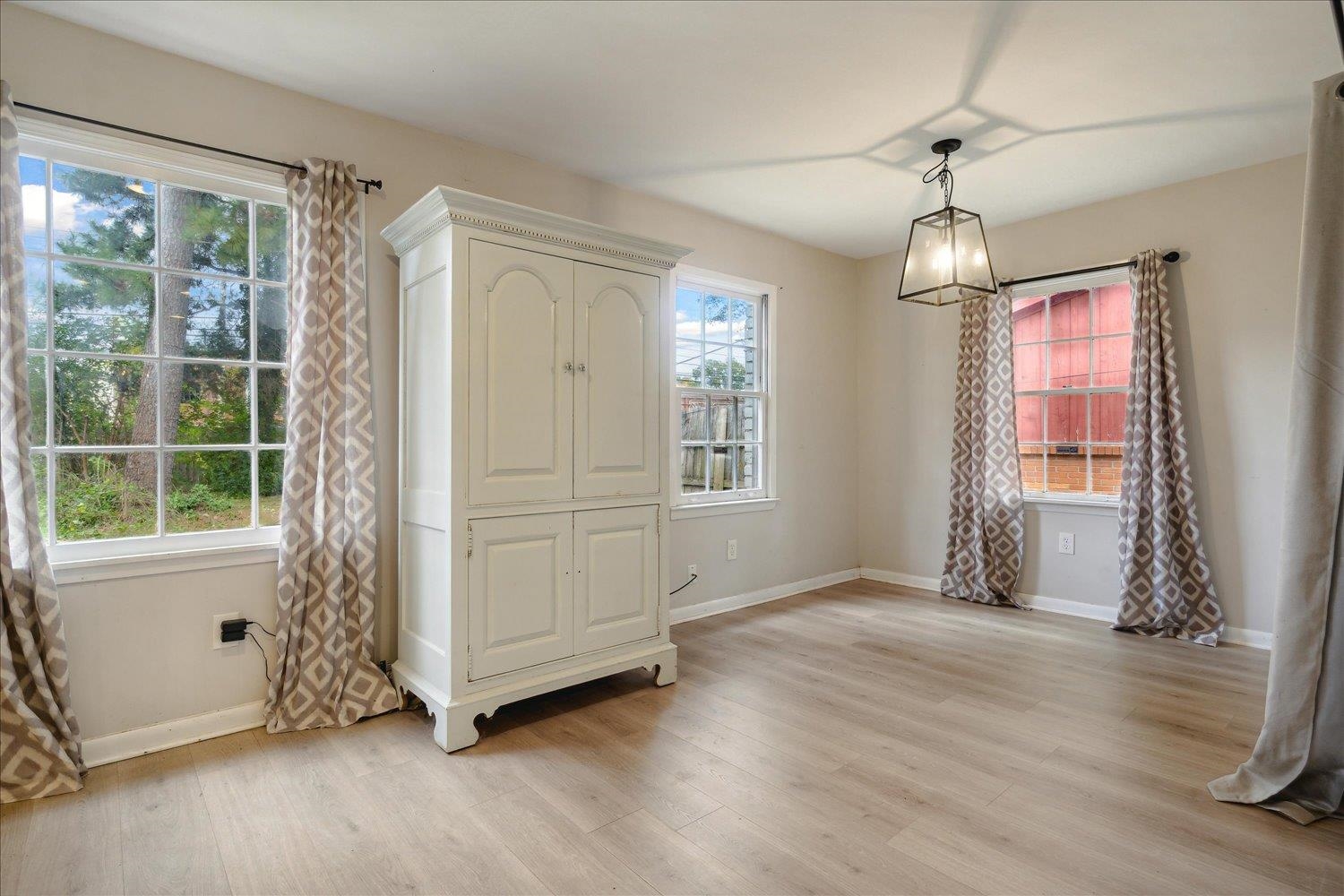 Entrance foyer featuring light wood-type flooring, plenty of natural light, and a notable chandelier