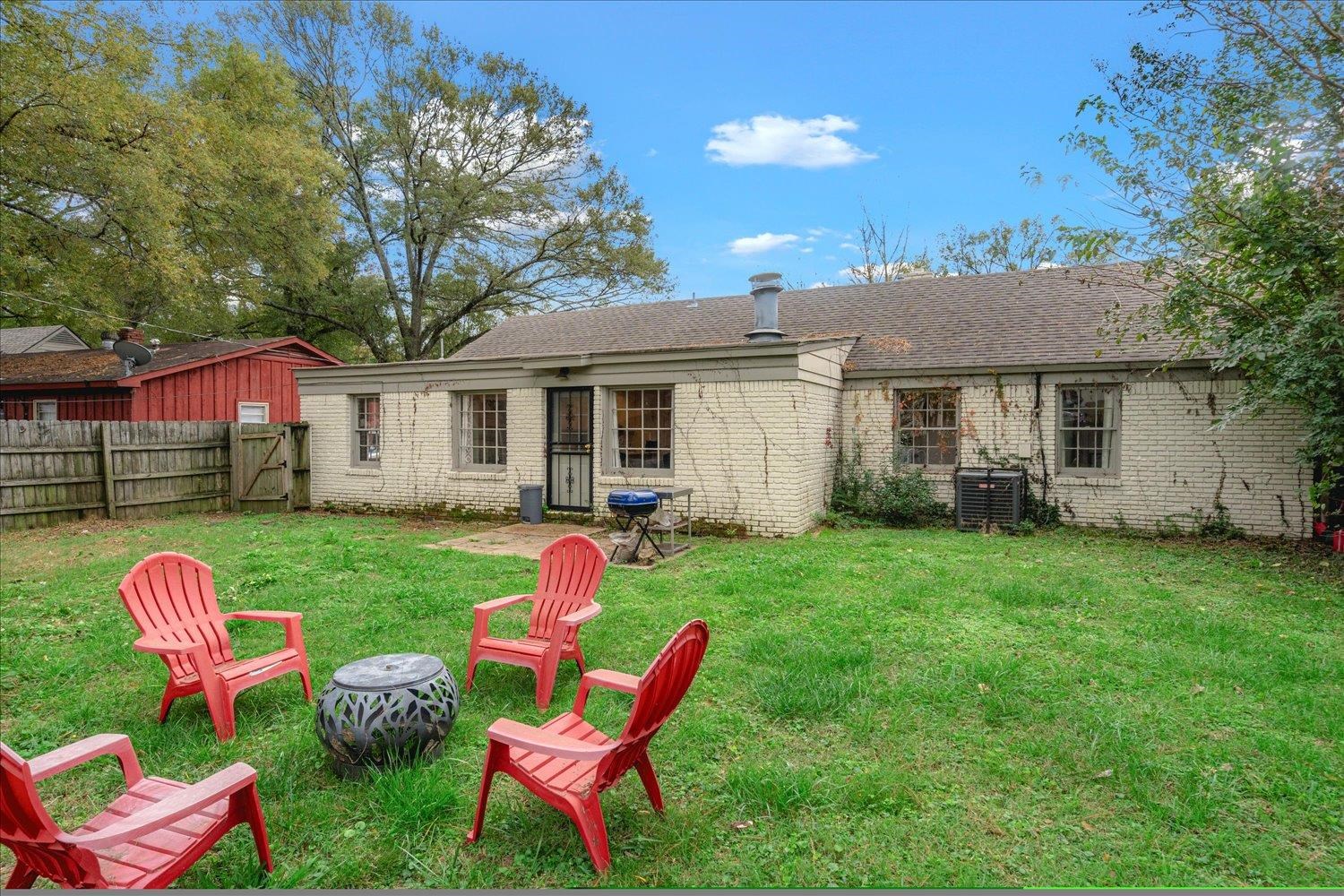 Back of house featuring a yard