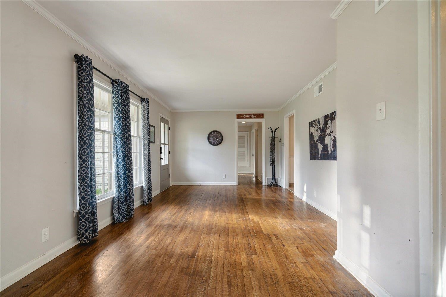 Spare room with hardwood / wood-style flooring and ornamental molding