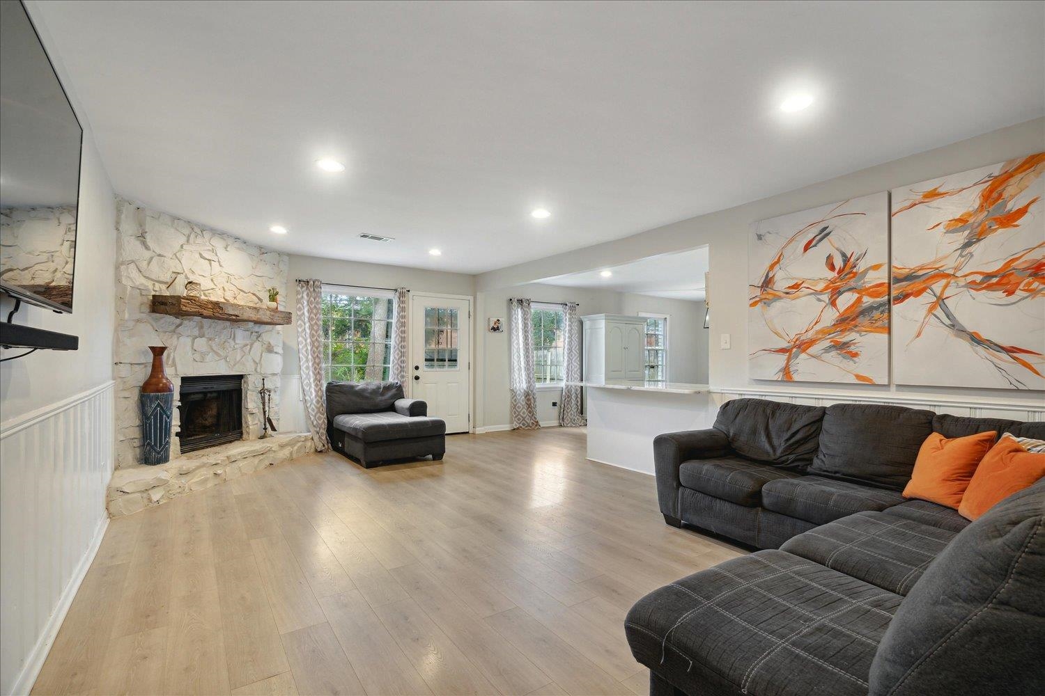 Living room featuring light wood-type flooring and a fireplace