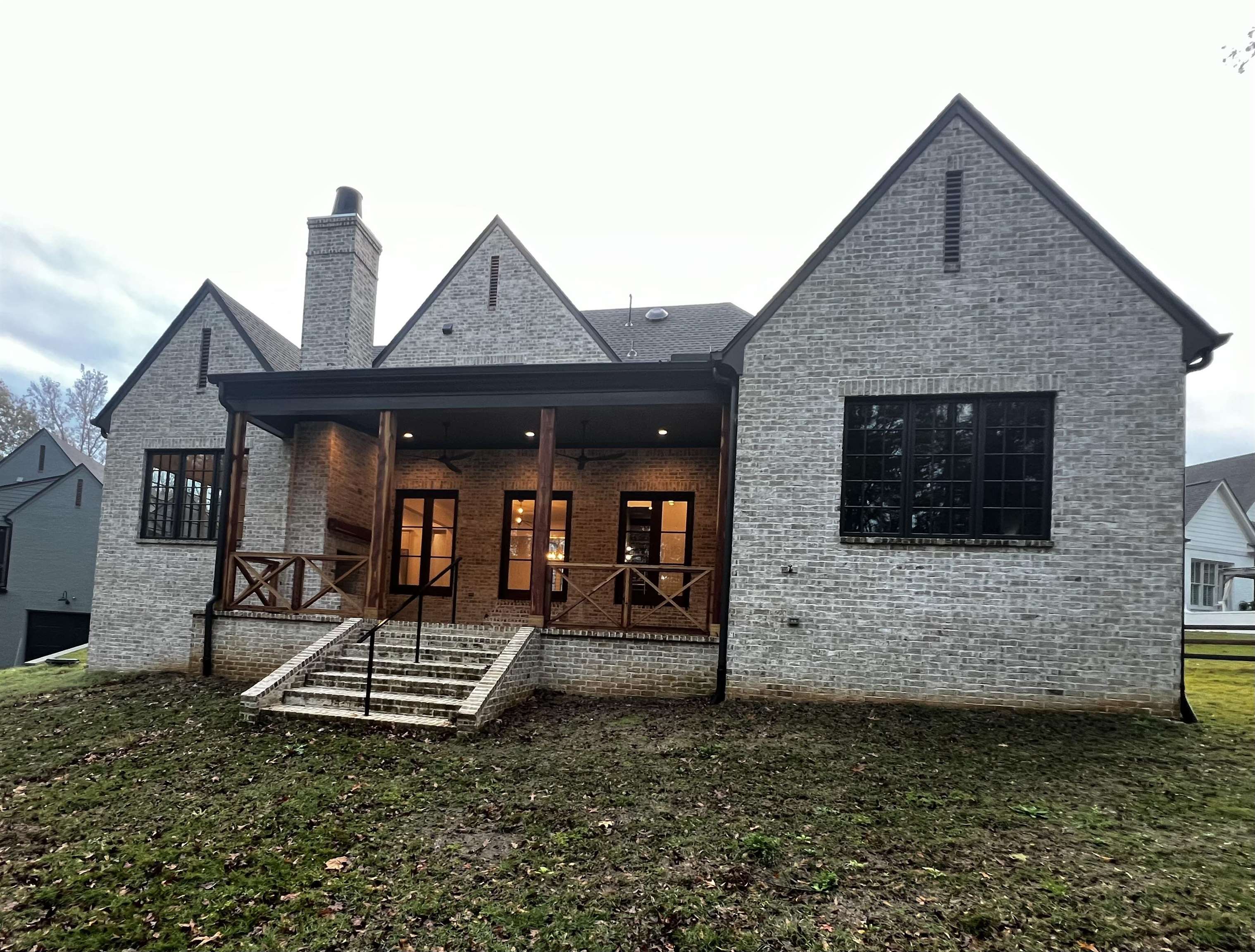 Back of house featuring a porch and a lawn