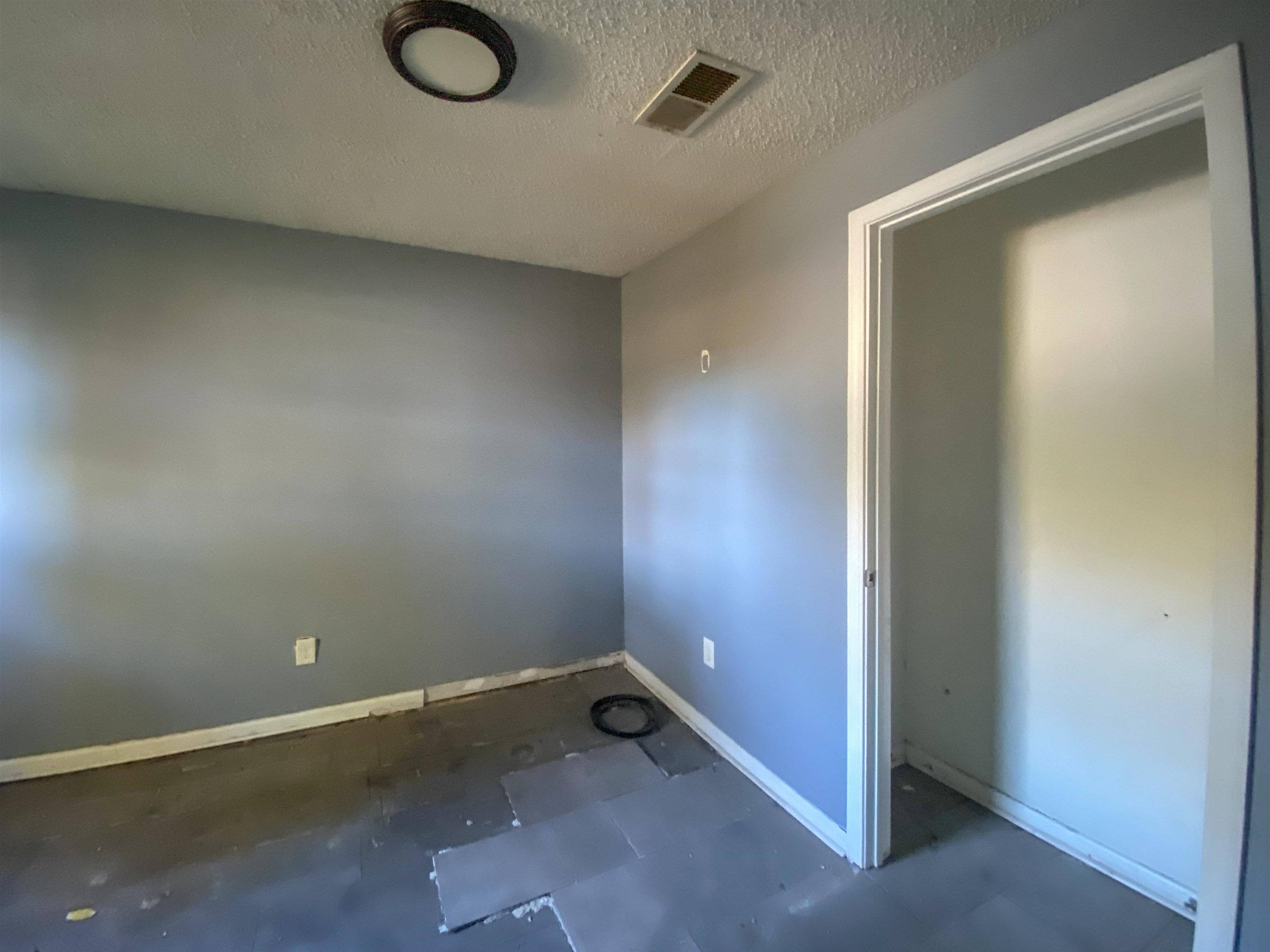 Empty room with a textured ceiling