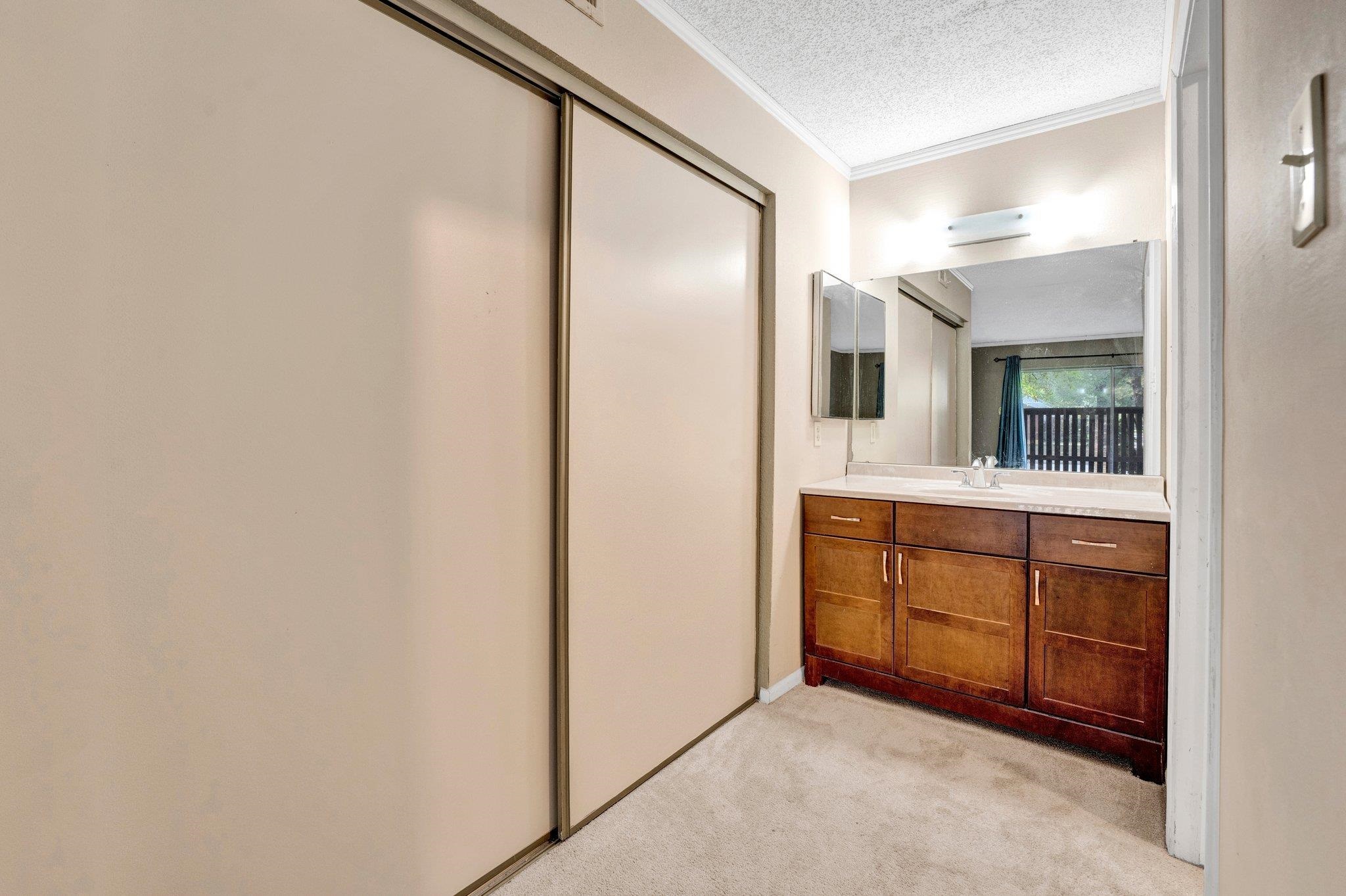 Bathroom in primary and one of two closets in primary bedroom