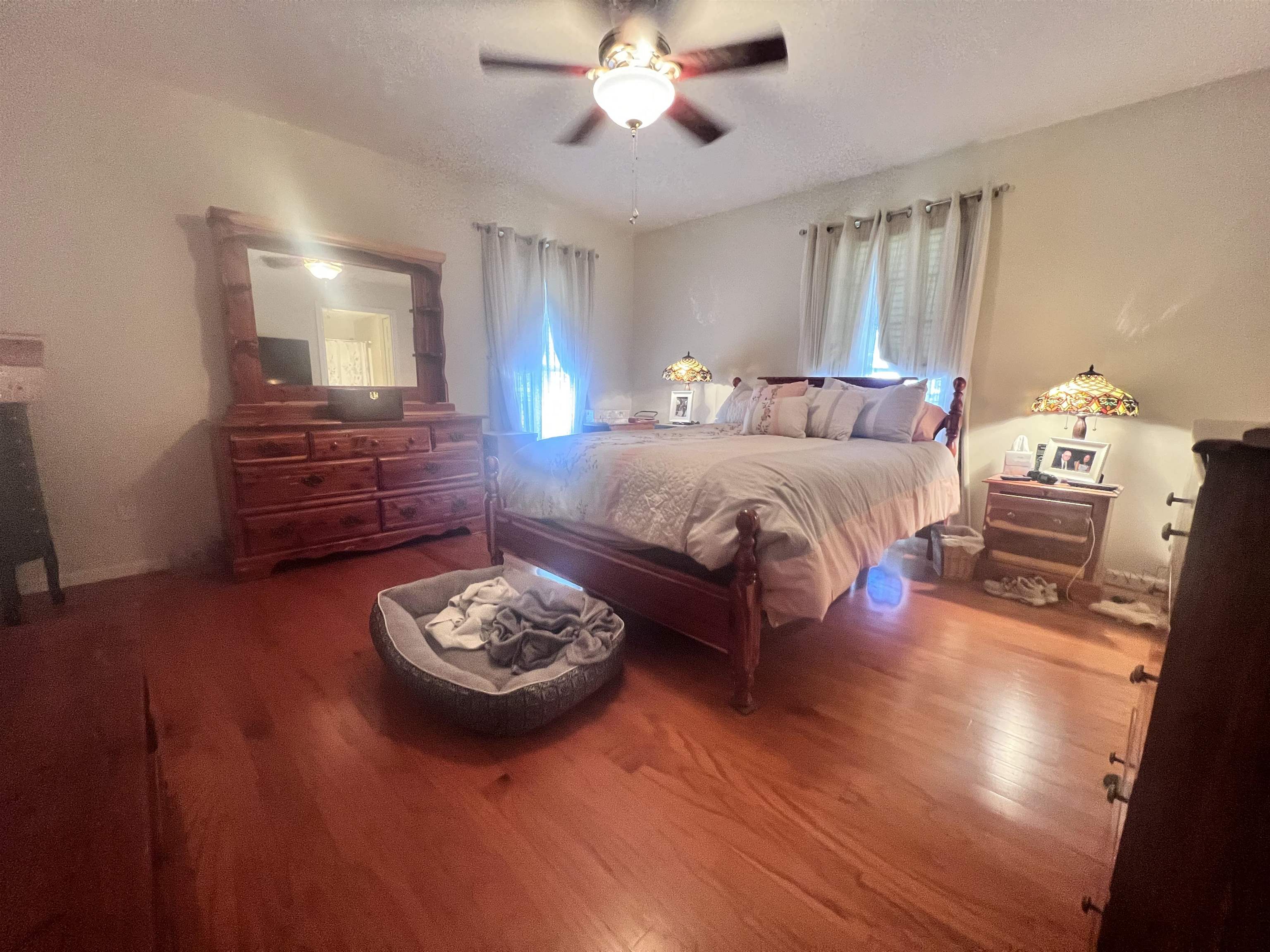 Bedroom featuring ceiling fan and hardwood / wood-style floors