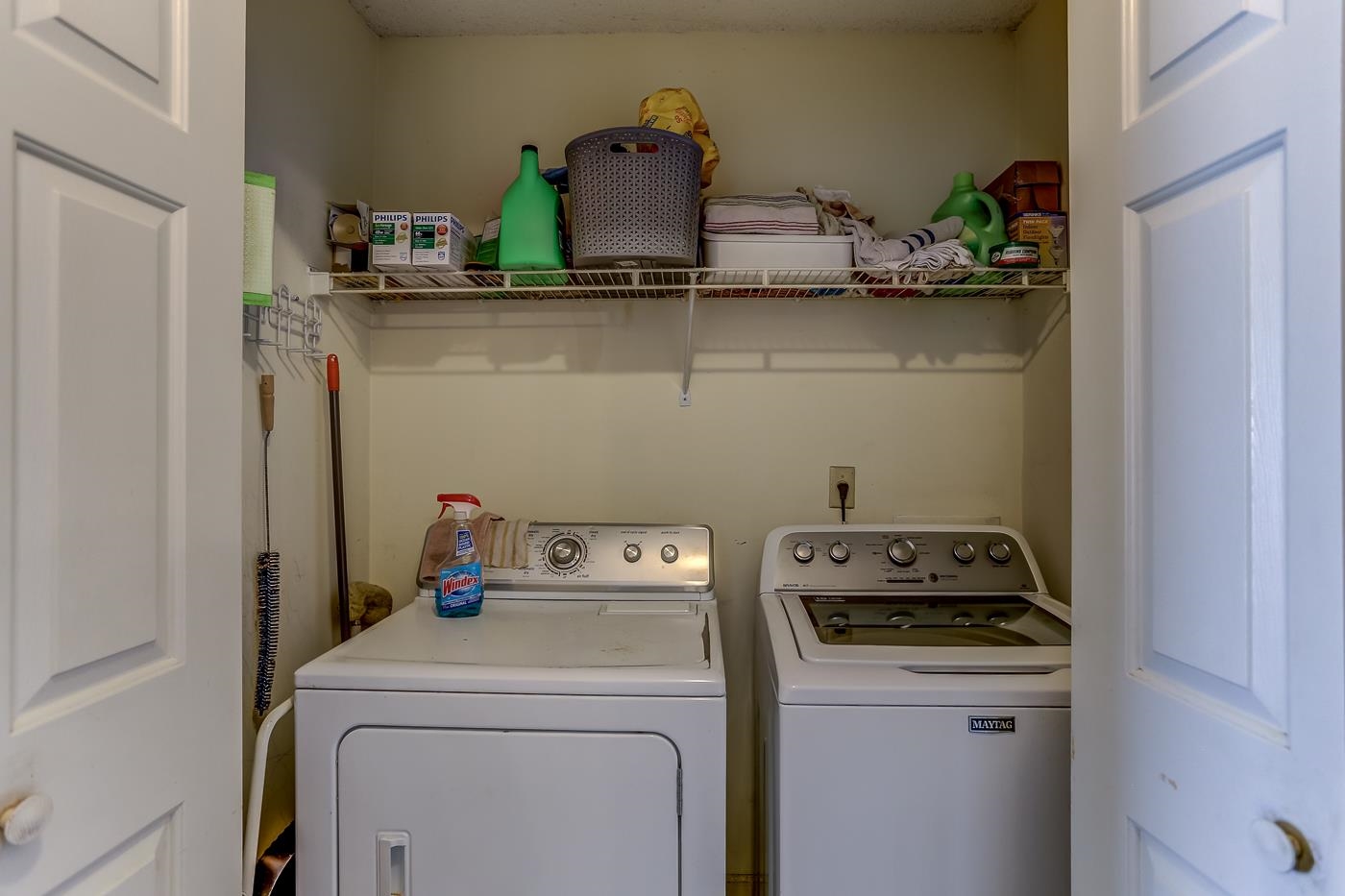 Washroom with washing machine and clothes dryer