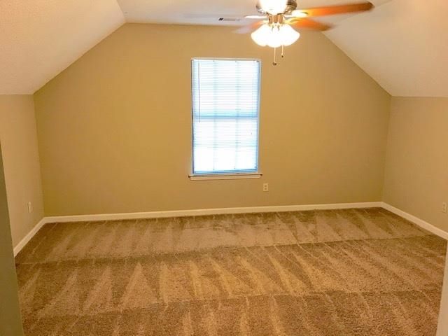 Bonus room with ceiling fan, carpet floors, and vaulted ceiling