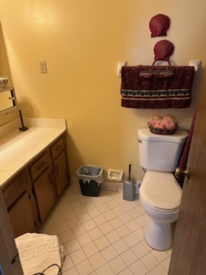 Bathroom with tile patterned floors, vanity, and toilet