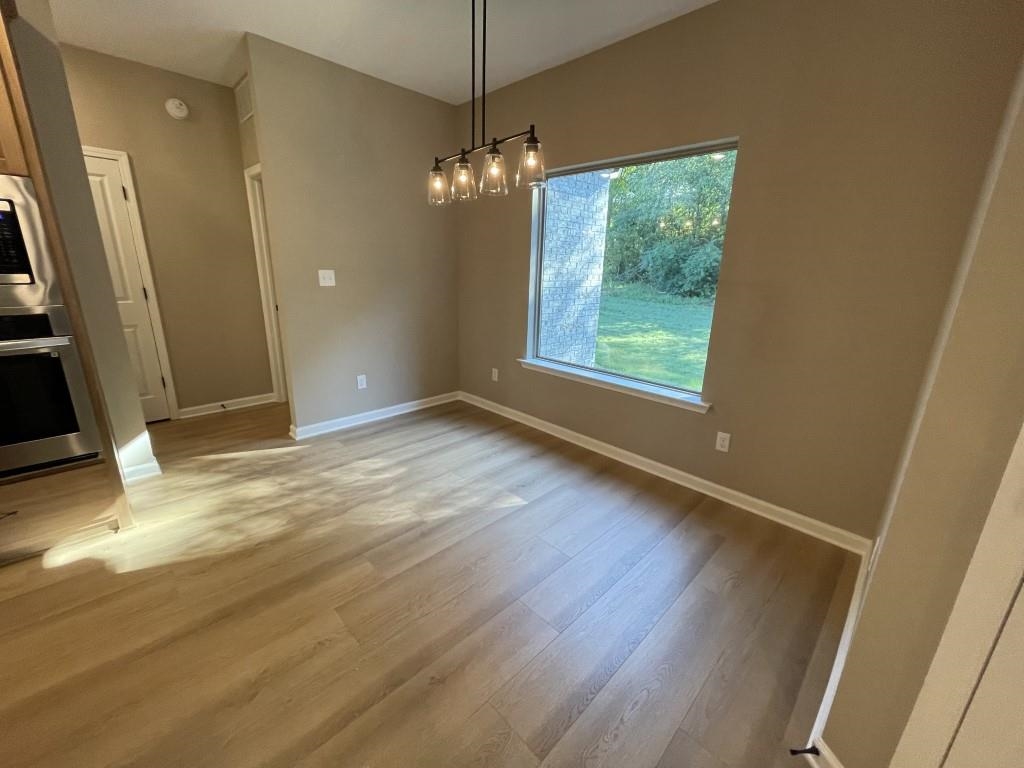 Unfurnished dining area with light wood-type flooring