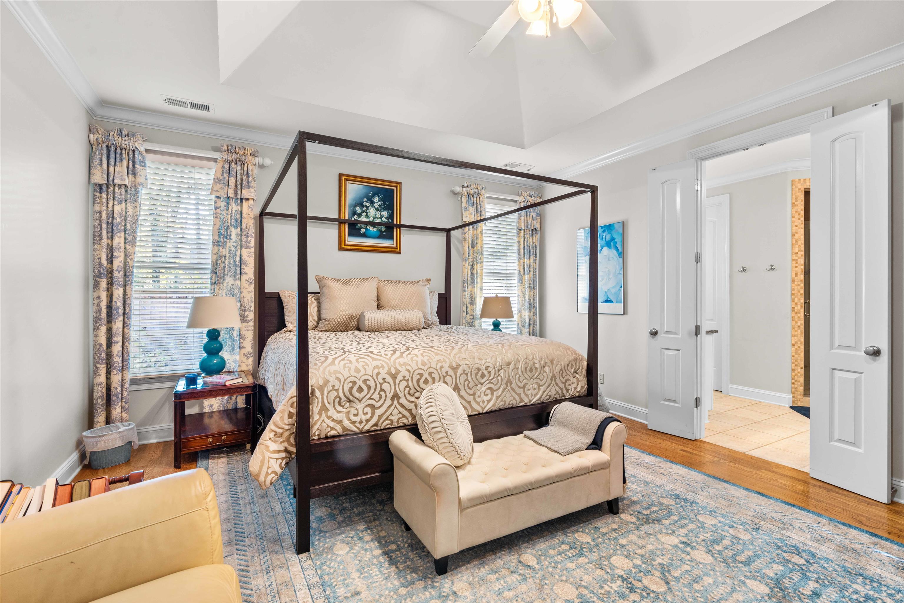 Bedroom with wood-type flooring, ceiling fan, and ornamental molding