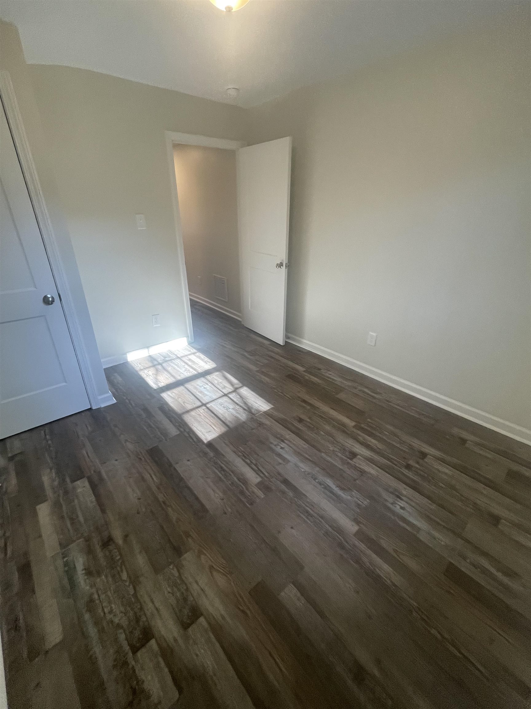 Spare room with dark hardwood / wood-style flooring