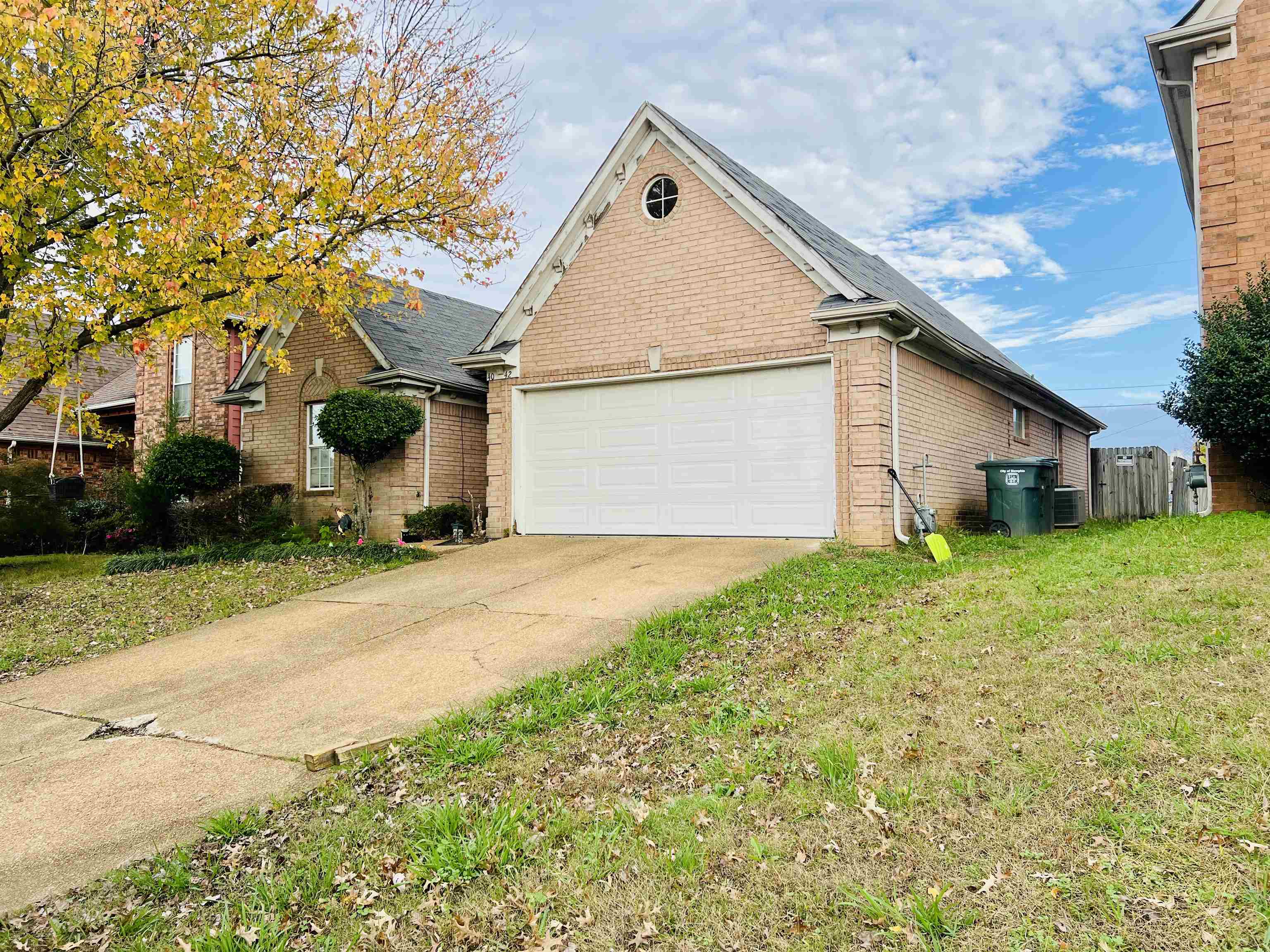 View of side of property with a garage and a yard