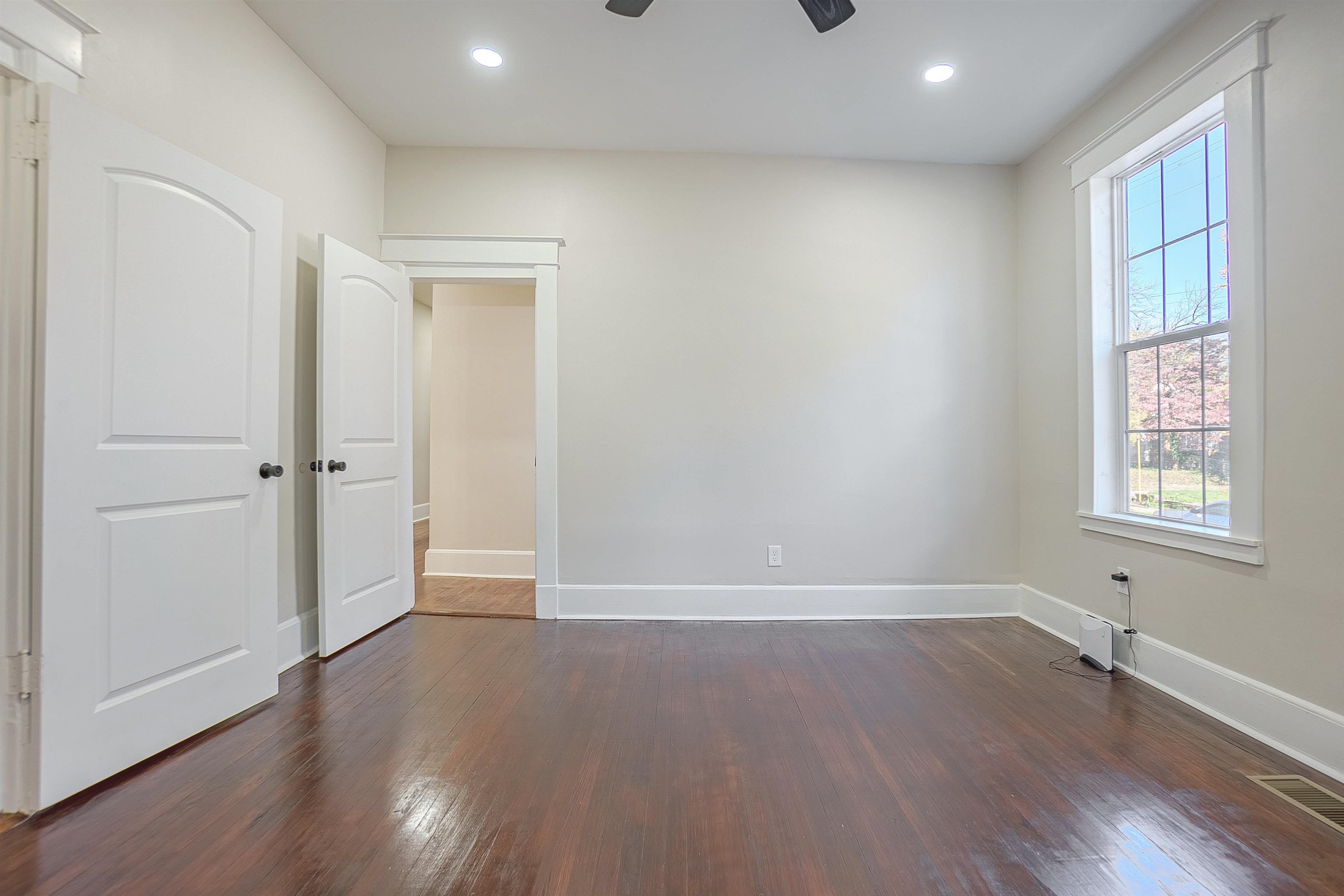 Interior space with dark hardwood / wood-style floors and ceiling fan