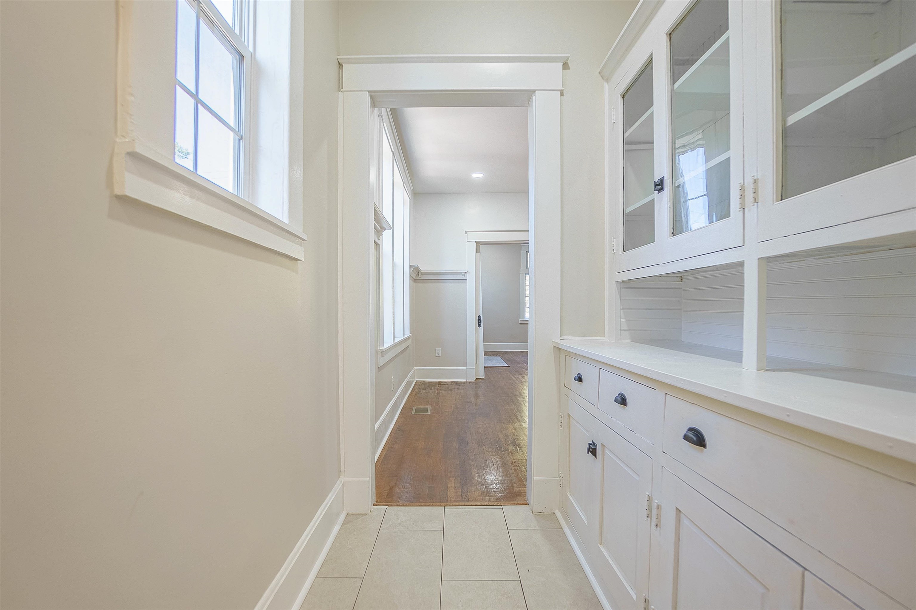 Corridor with a healthy amount of sunlight and light hardwood / wood-style floors