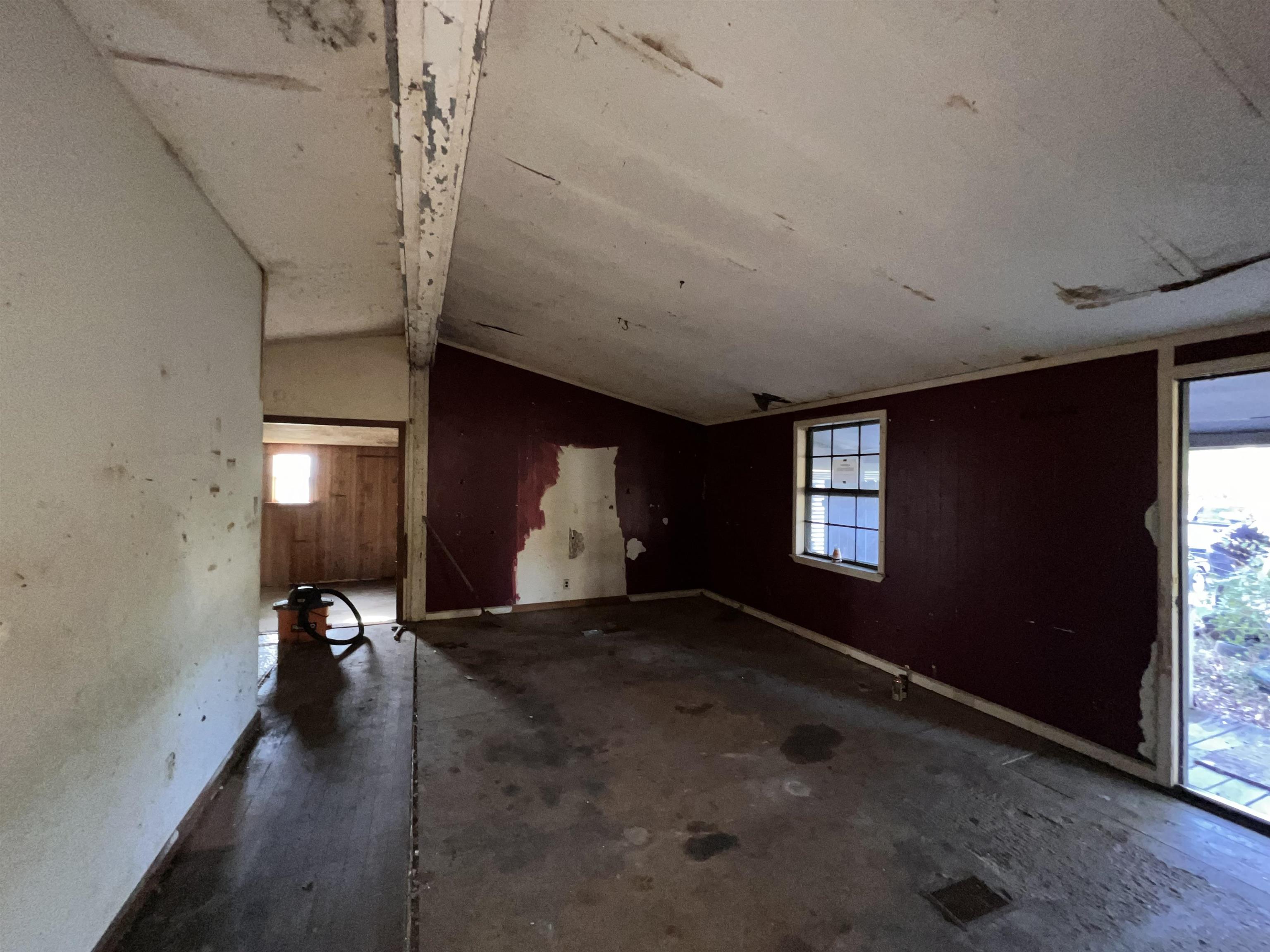 Empty room featuring a healthy amount of sunlight and lofted ceiling