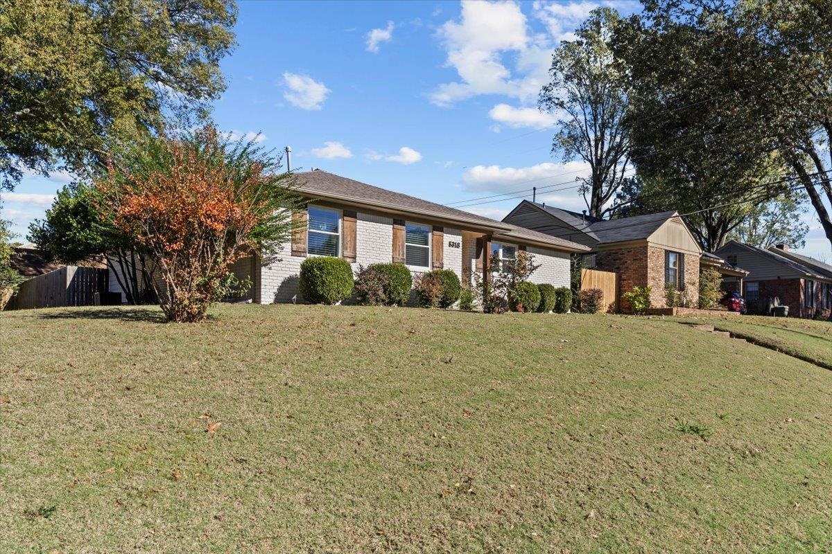 Single story home featuring a front lawn