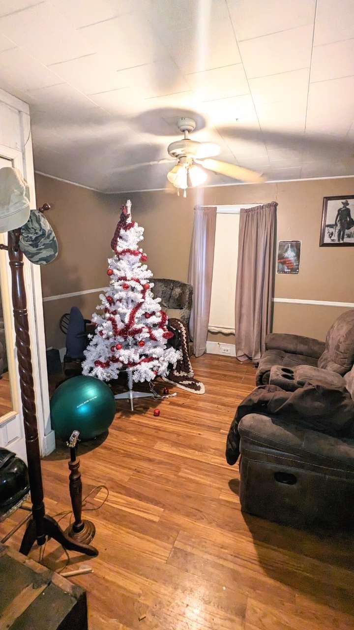 Bedroom with ceiling fan and hardwood / wood-style flooring