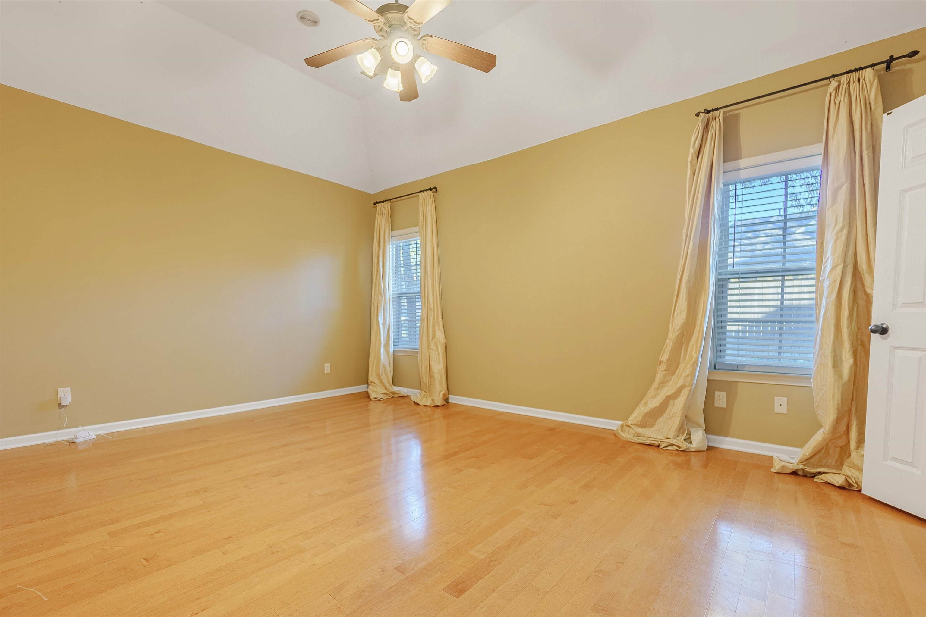 Spare room with ceiling fan and light wood-type flooring