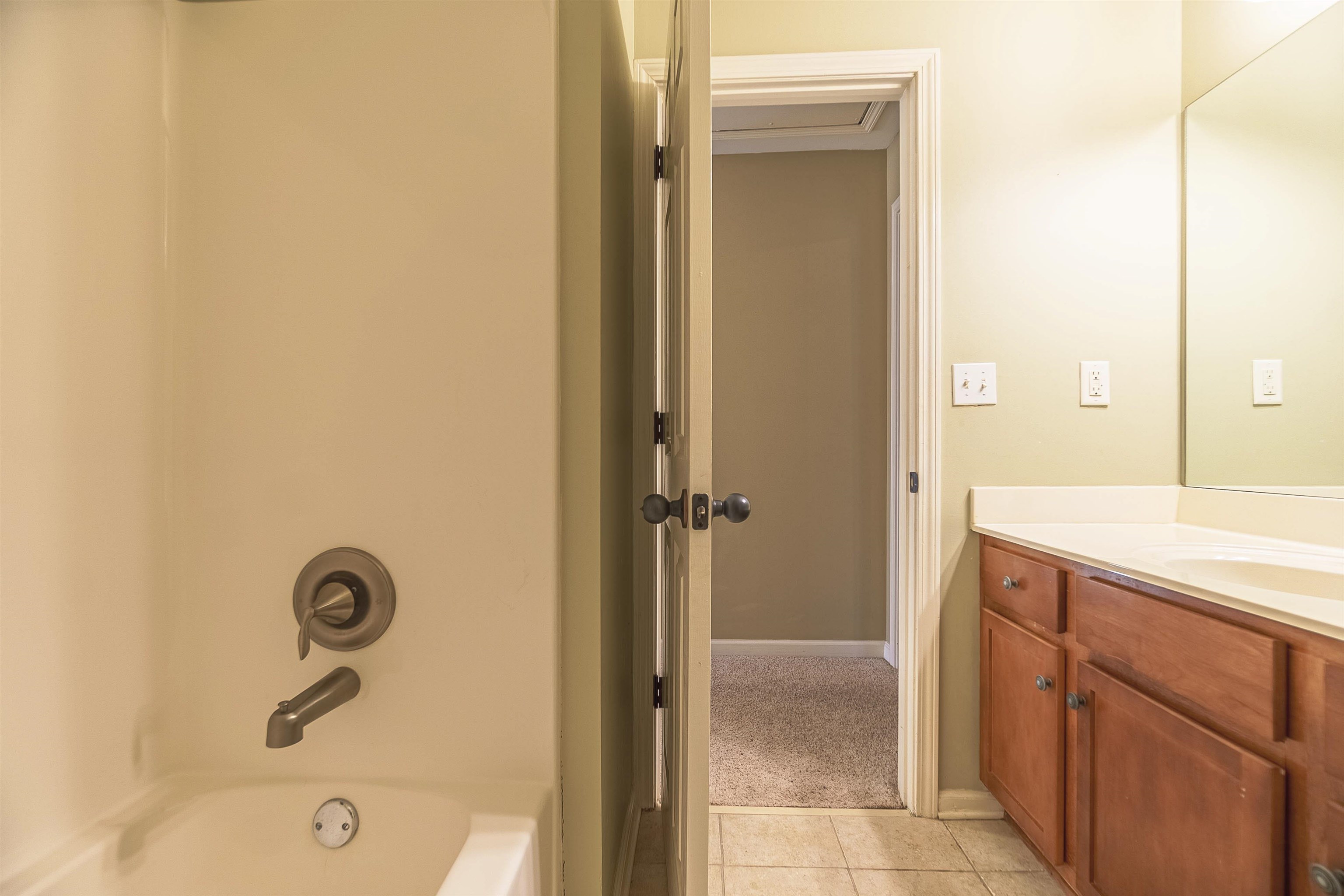 Bathroom with vanity, tile patterned floors, and  shower combination