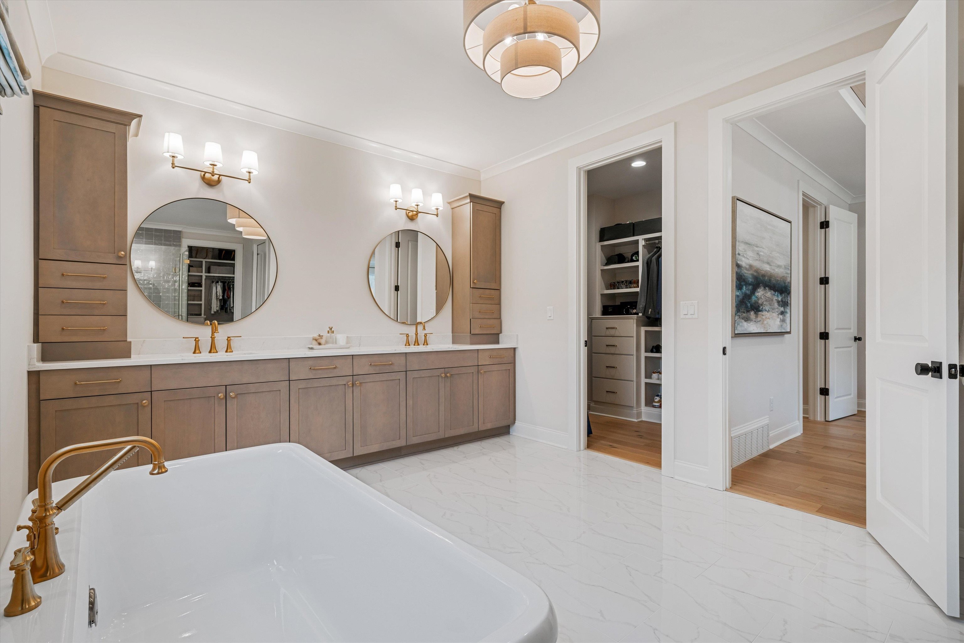 Bathroom with a bathtub, vanity, hardwood / wood-style flooring, and crown molding