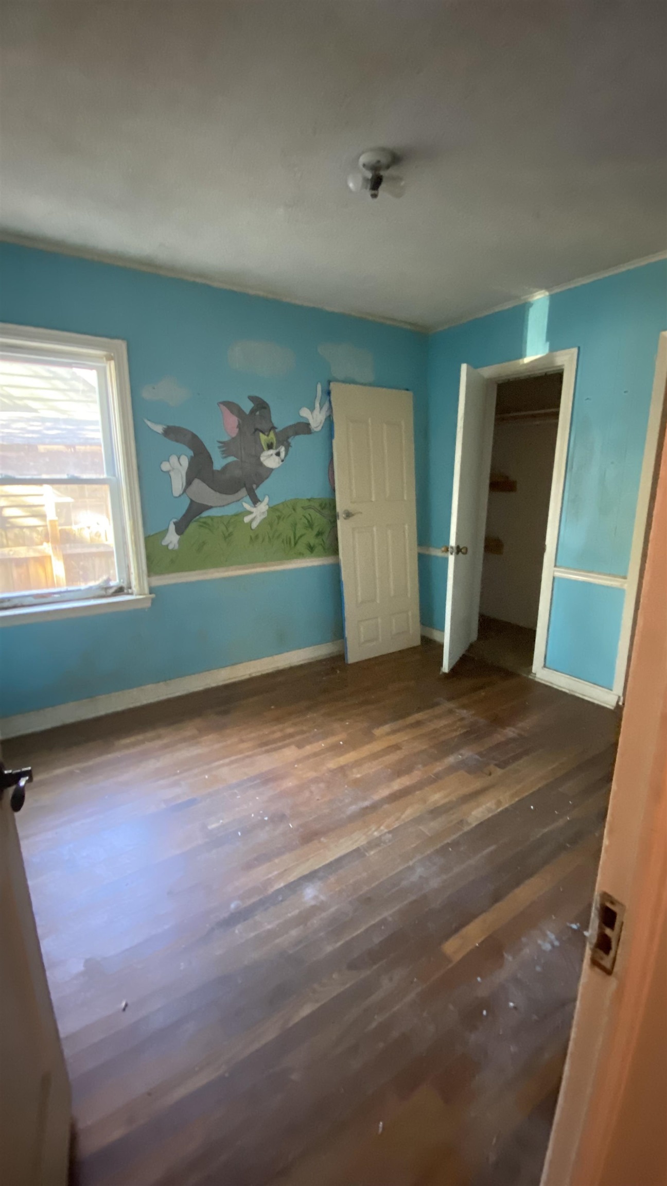 Unfurnished bedroom with dark wood-type flooring