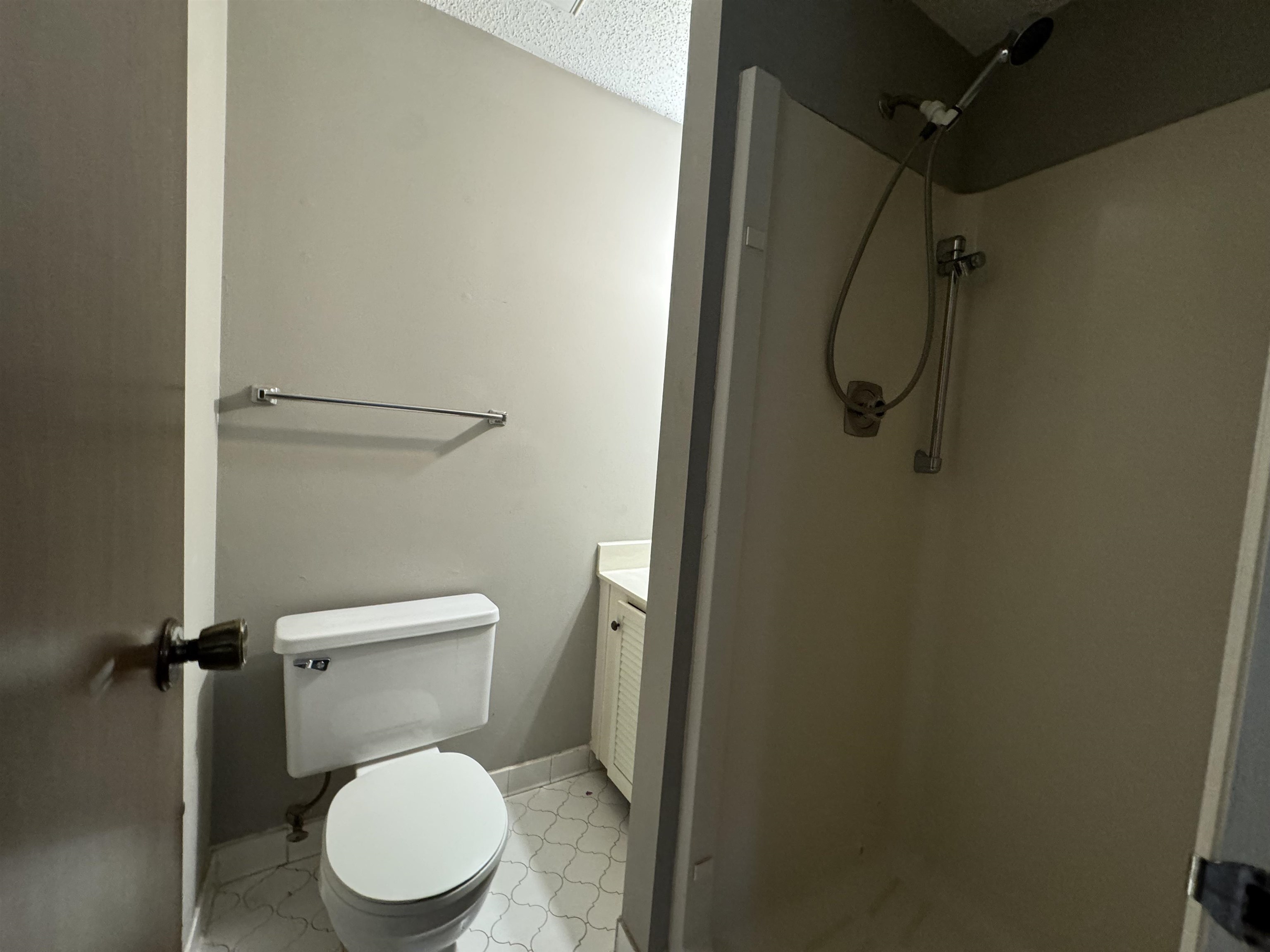 Bathroom with a shower, vanity, and toilet