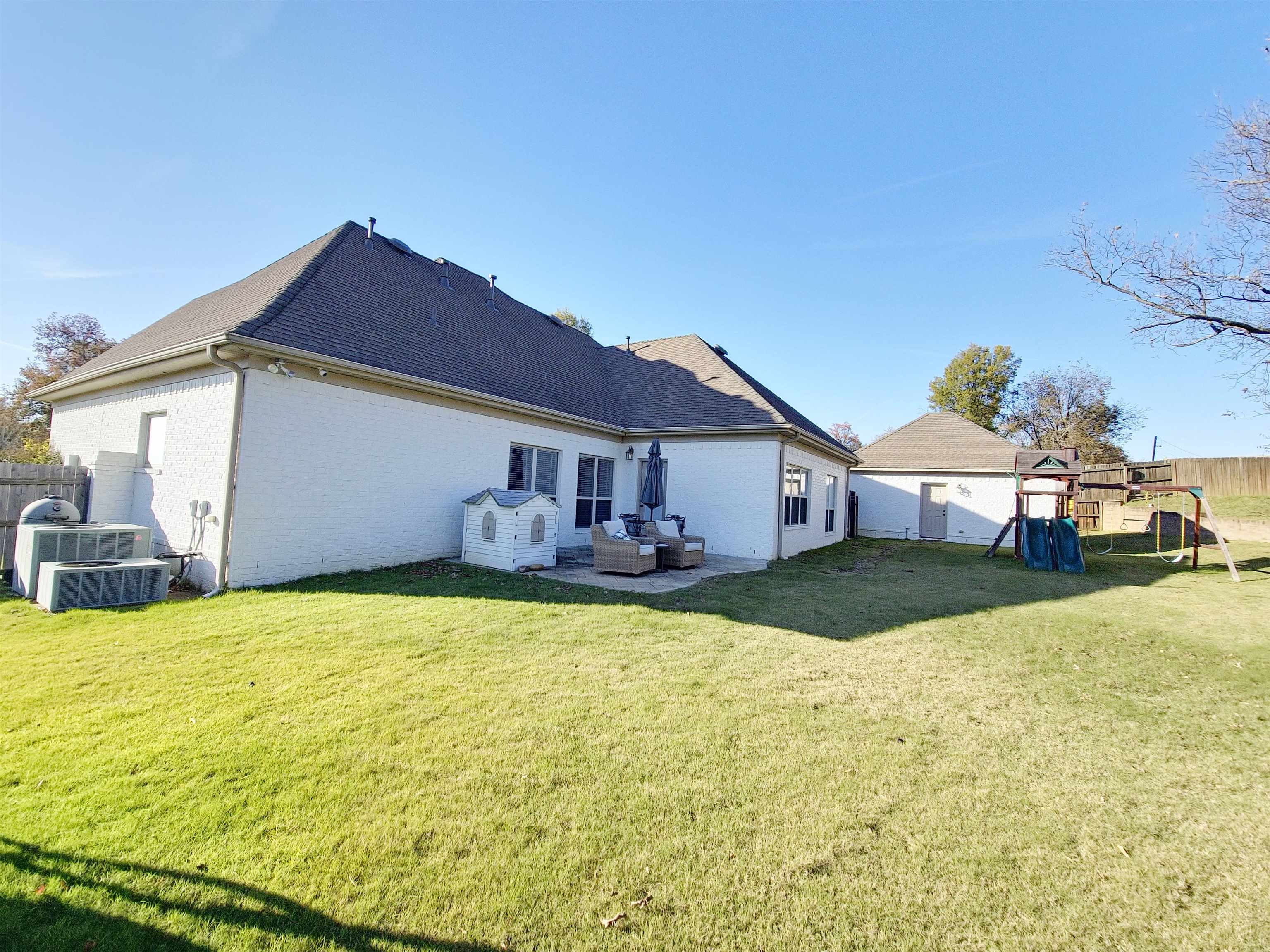 Back of house featuring a yard, a playground, an outdoor hangout area, and a patio area