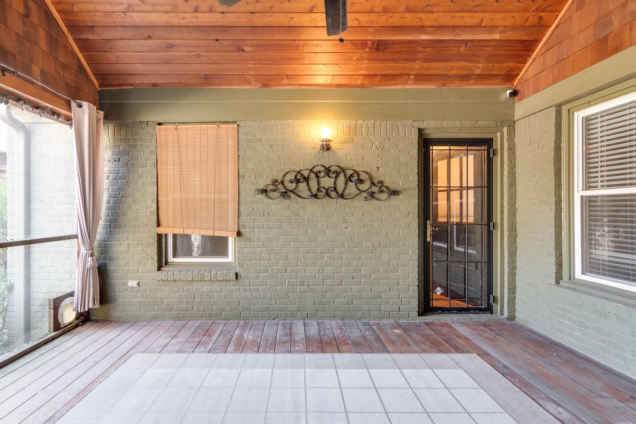 Unfurnished sunroom with wooden ceiling and lofted ceiling