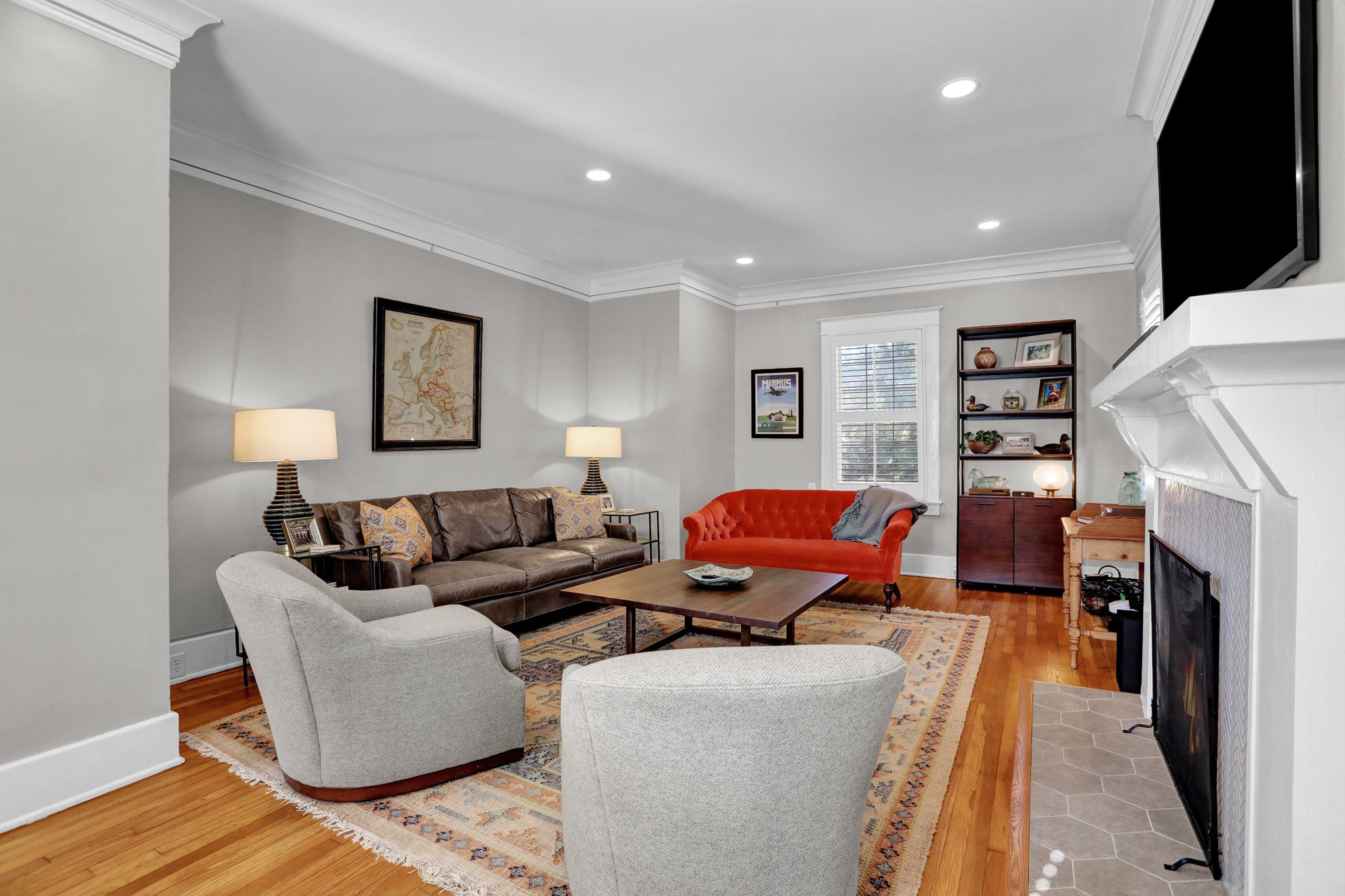 Living room featuring light wood-type flooring and crown molding