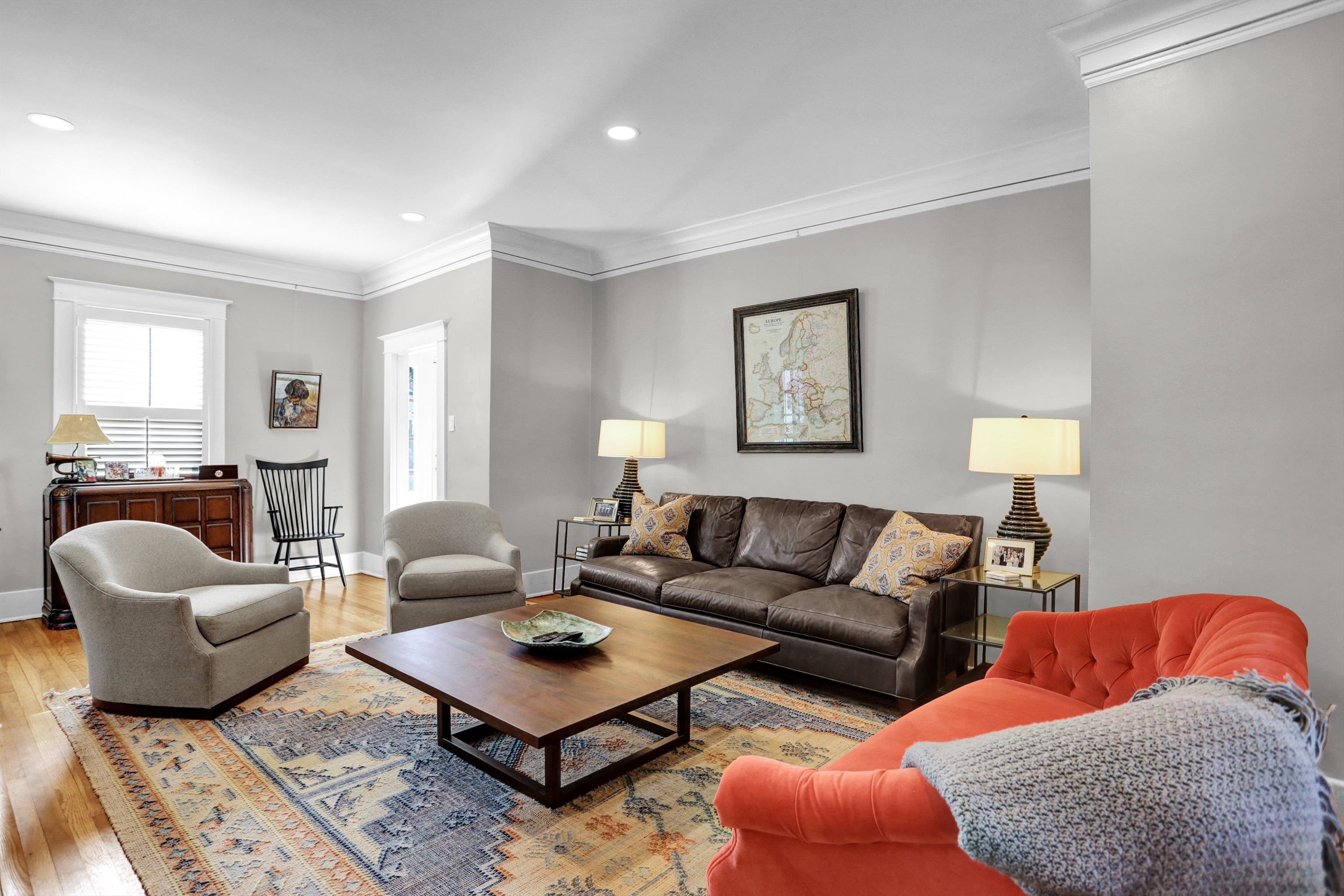 Living room featuring light wood-type flooring and ornamental molding