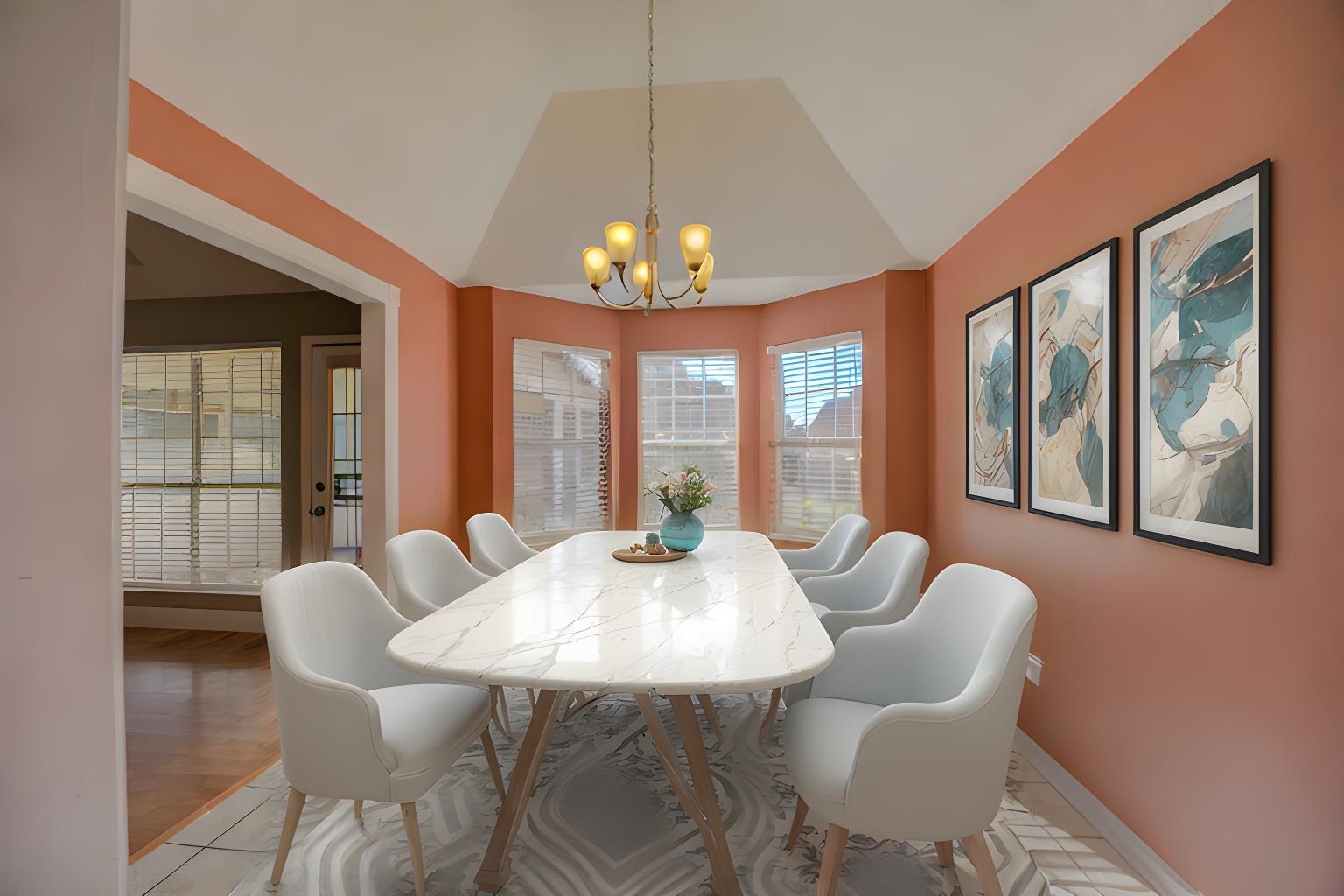 Dining room featuring a notable chandelier, light hardwood / wood-style floors, and lofted ceiling