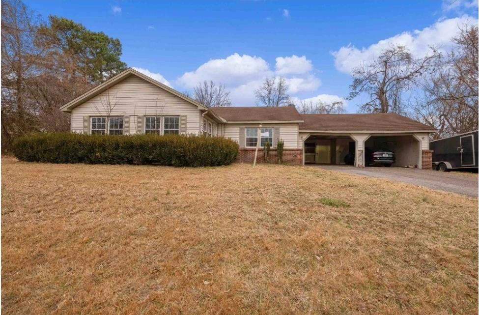 Single story home with a front lawn