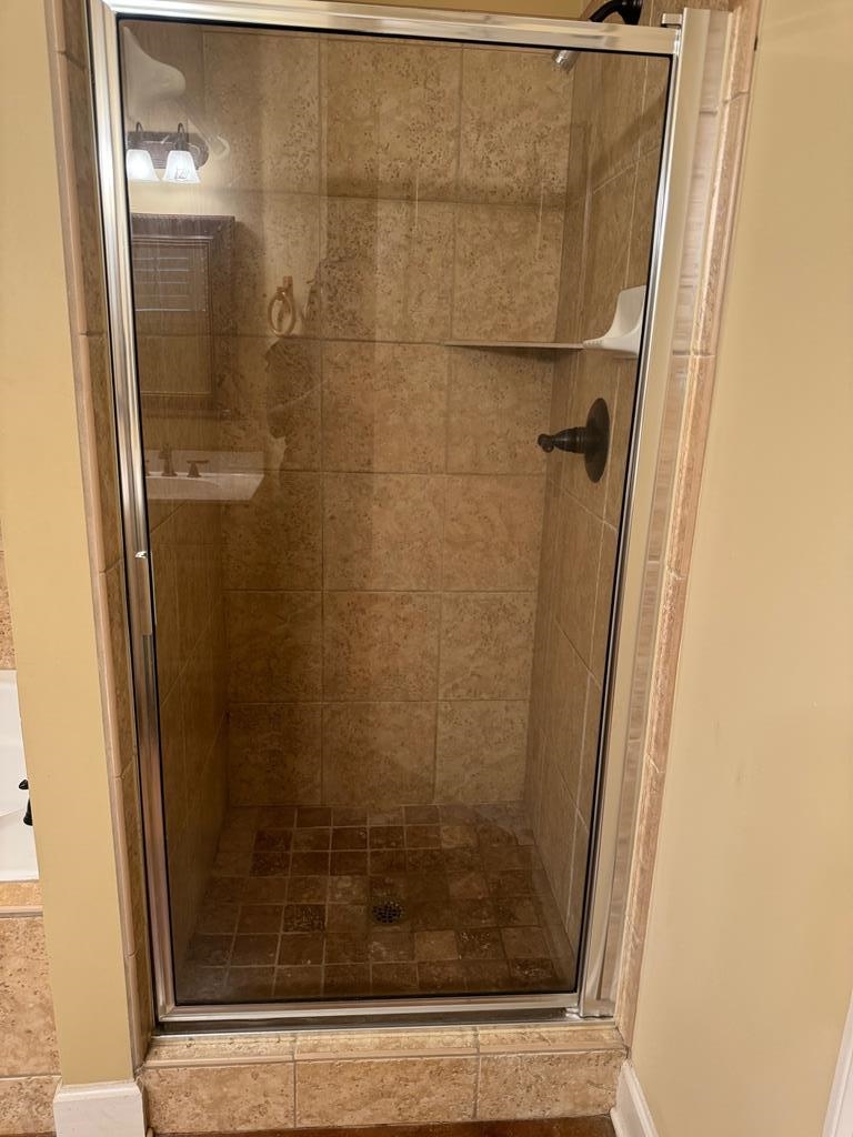 Bathroom featuring a shower with door