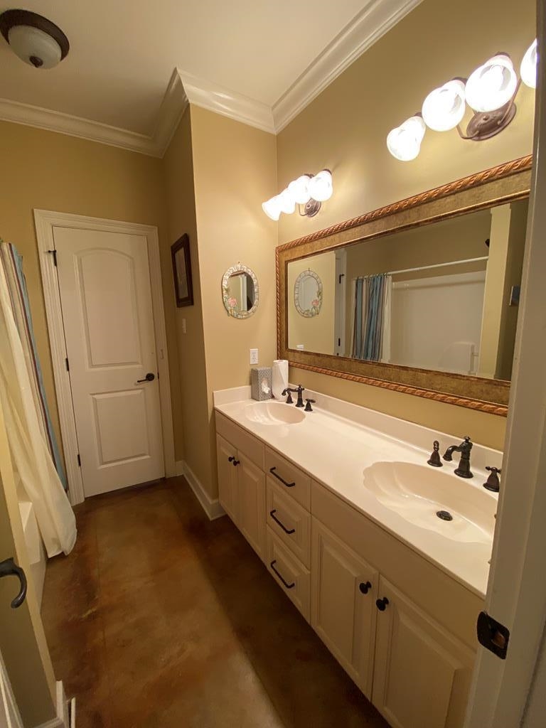 Bathroom with vanity and ornamental molding