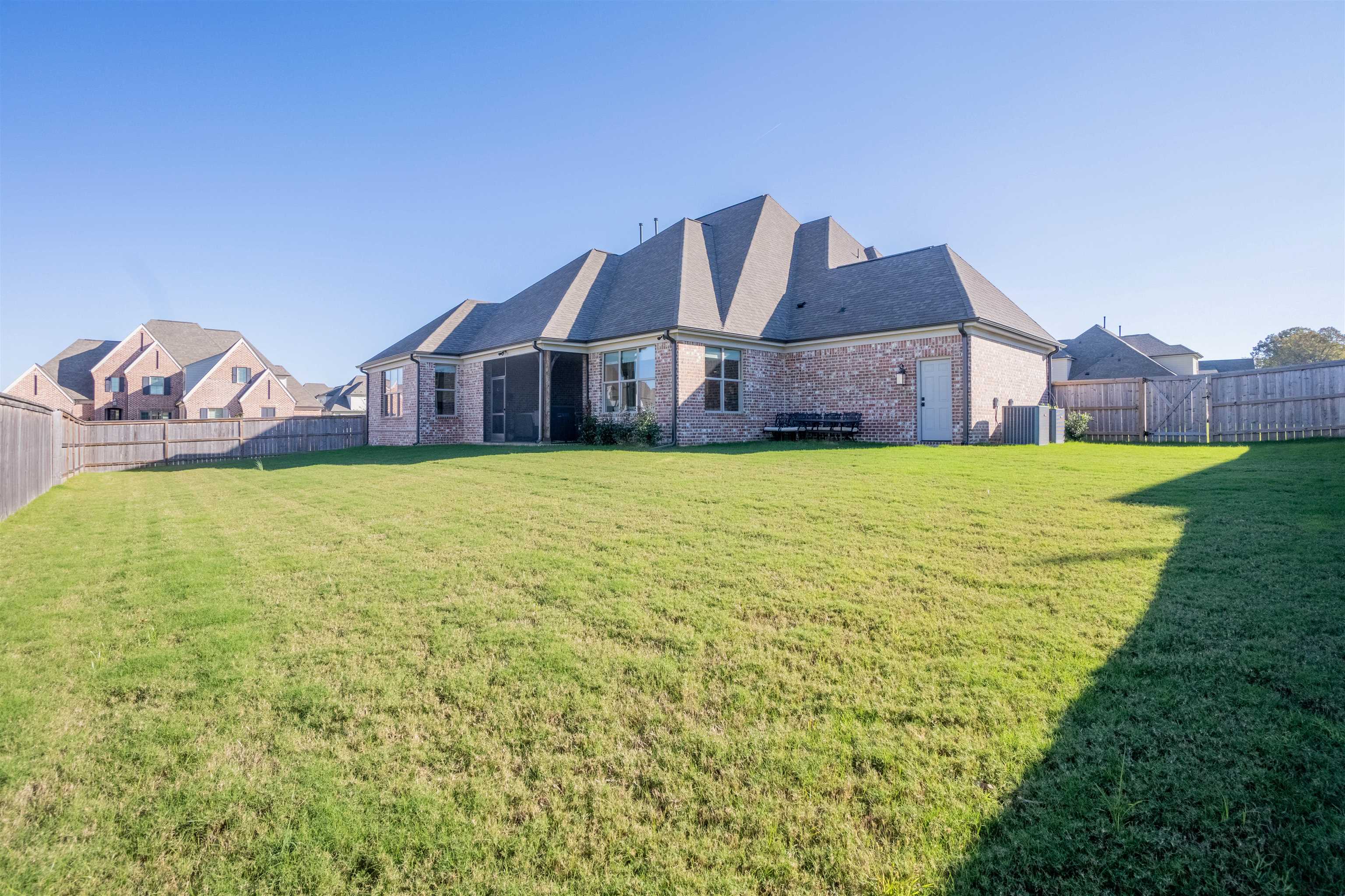 Rear view of property with a yard