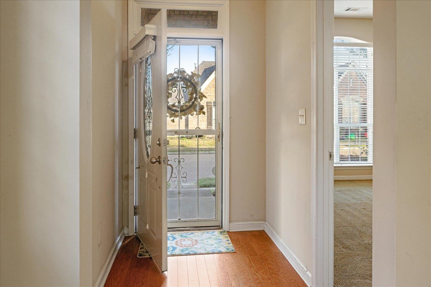 Entrance foyer with a healthy amount of sunlight and hardwood / wood-style flooring