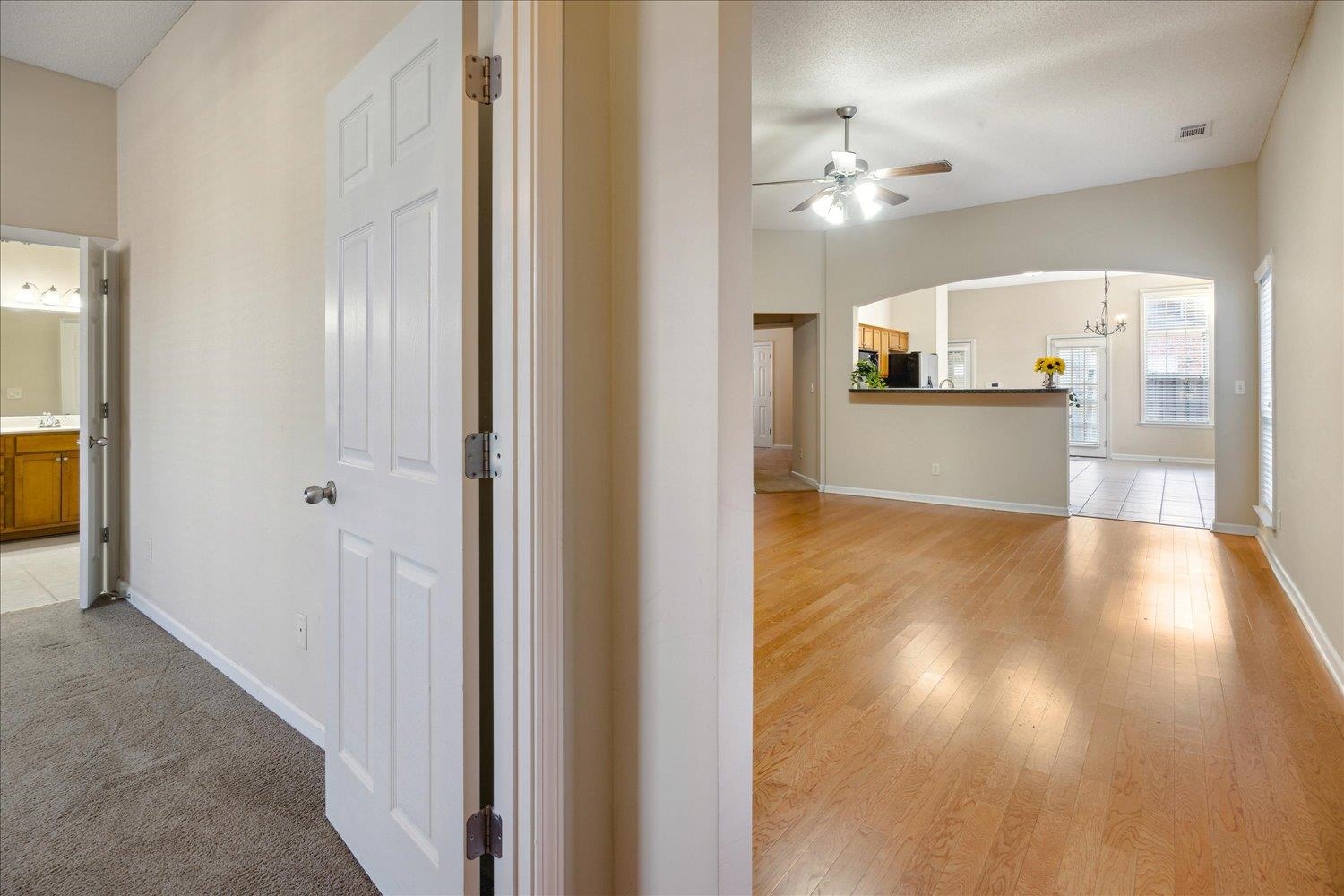 Hall featuring a textured ceiling, light hardwood / wood-style floors, and sink