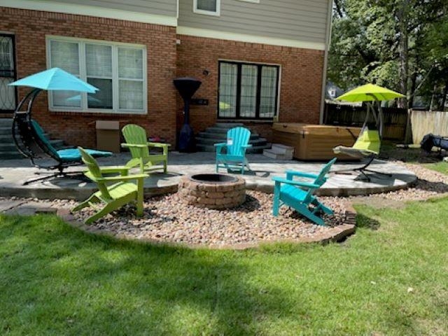 View of patio / terrace featuring a hot tub and an outdoor fire pit