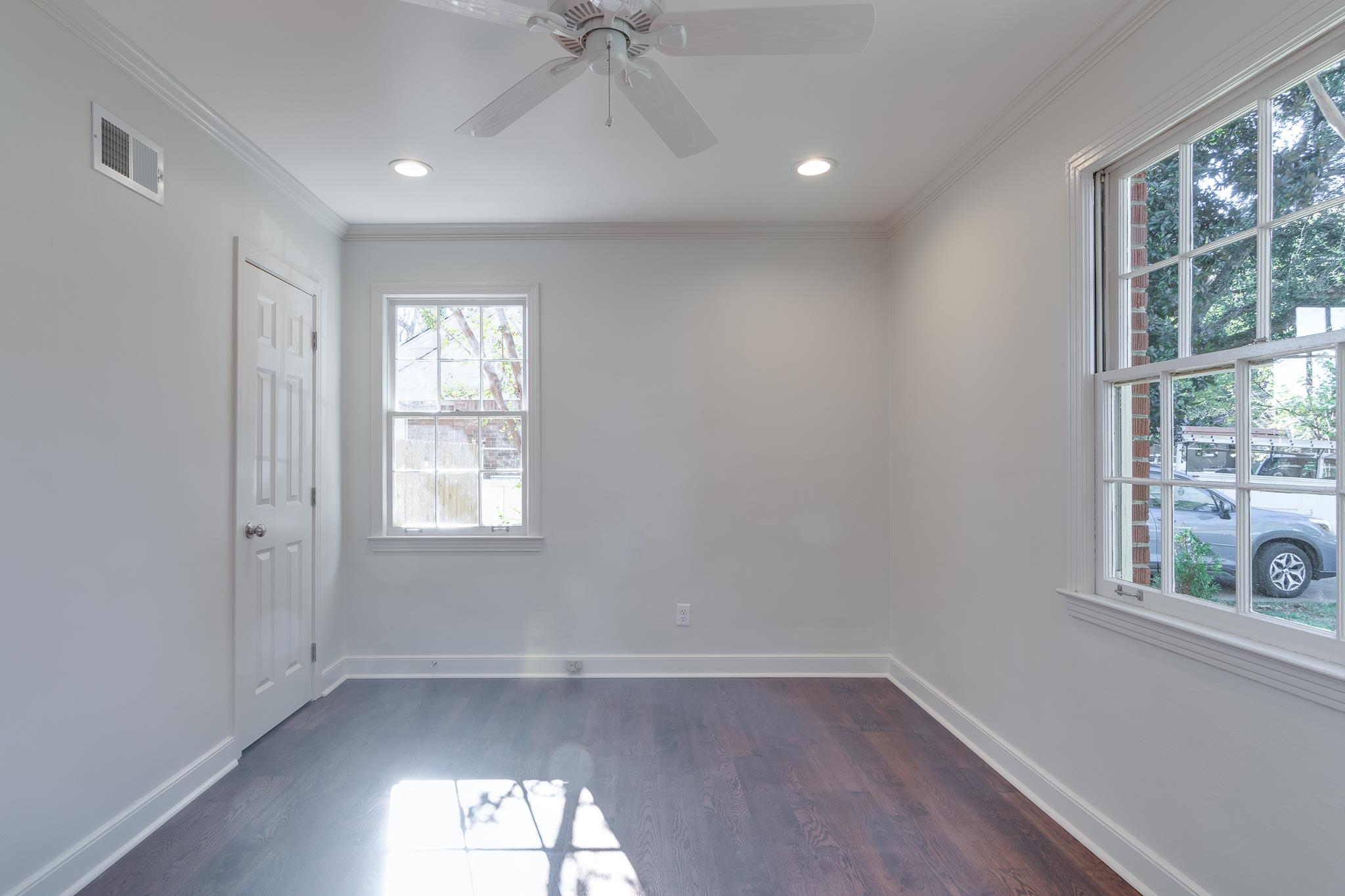 Unfurnished room with ceiling fan, dark hardwood / wood-style floors, and ornamental molding