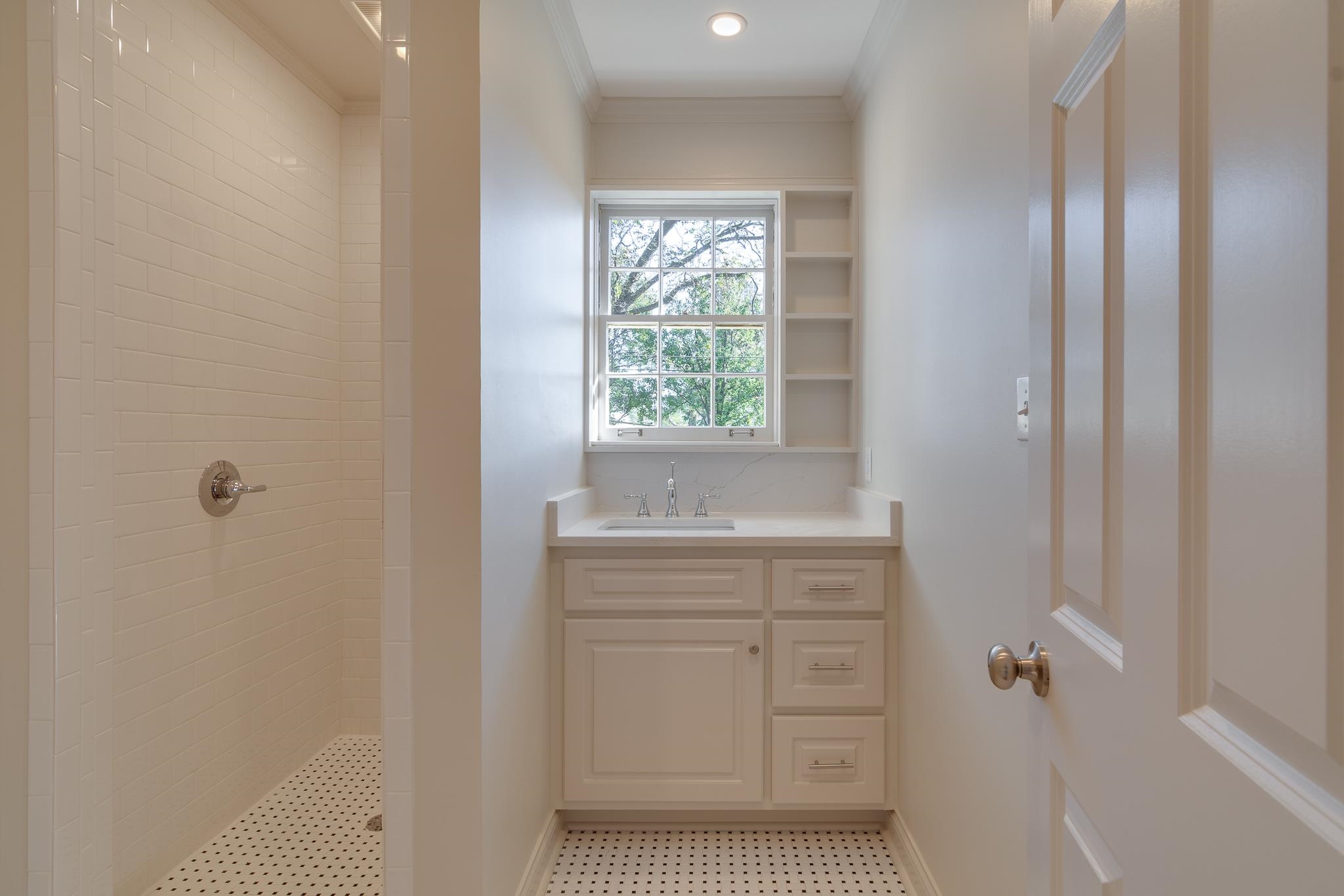 Bathroom featuring vanity and tiled shower